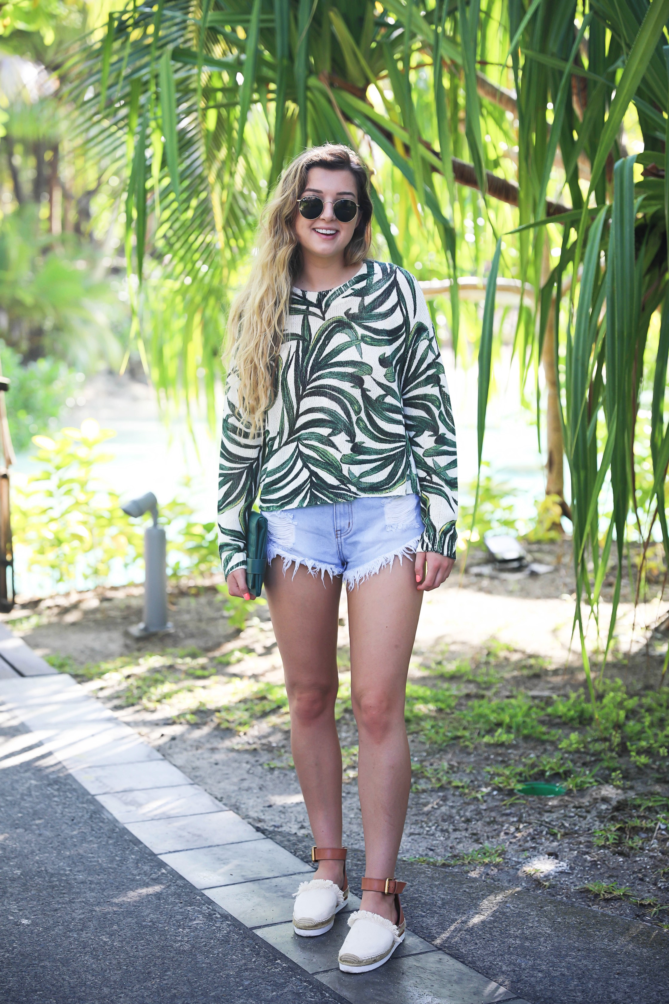 Show me your mumu palm sweater! Paired with cute cut off denim shorts from Showpo! Travel blogger in bora bora, French polynesia! I stayed at the Intercontinental! Details on fashion blog daily dose of charm by lauren lindmark