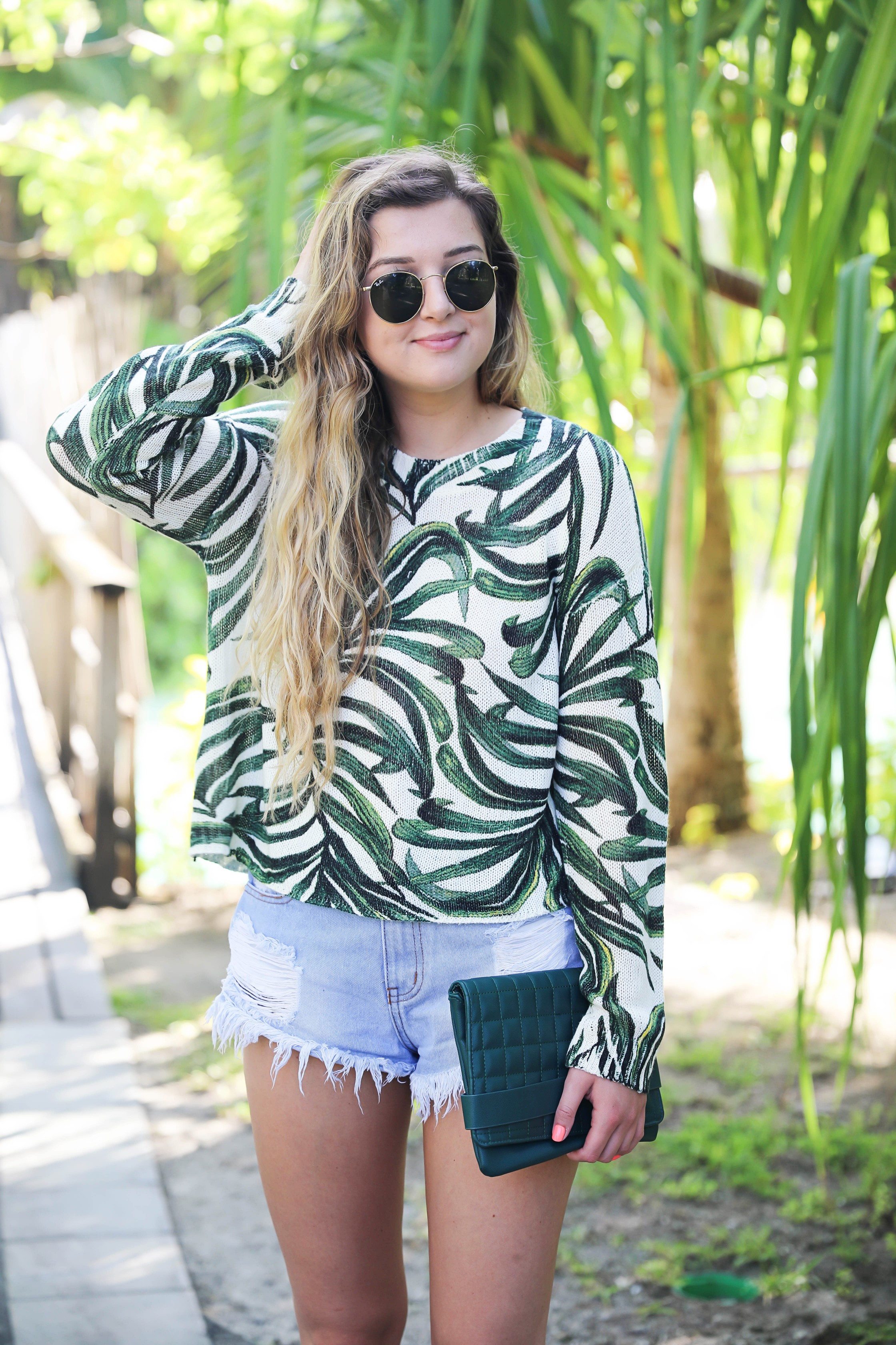 Show me your mumu palm sweater! Paired with cute cut off denim shorts from Showpo! Travel blogger in bora bora, French polynesia! I stayed at the Intercontinental! Details on fashion blog daily dose of charm by lauren lindmark