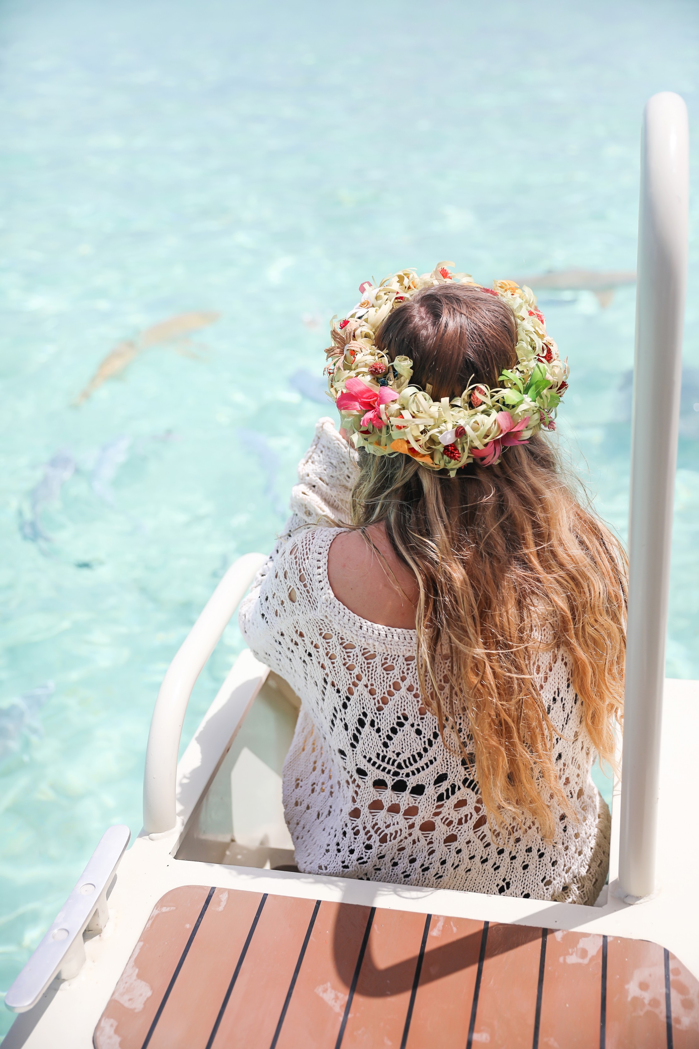 Swimming with sharks in Bora Bora, French Polynesia! I wore the prettiest Bora Bora flower crown by the ocean! The water was so clear and blue! Details on travel blog daily dose of charm by travel blogger and fashion blogger lauren lindmark
