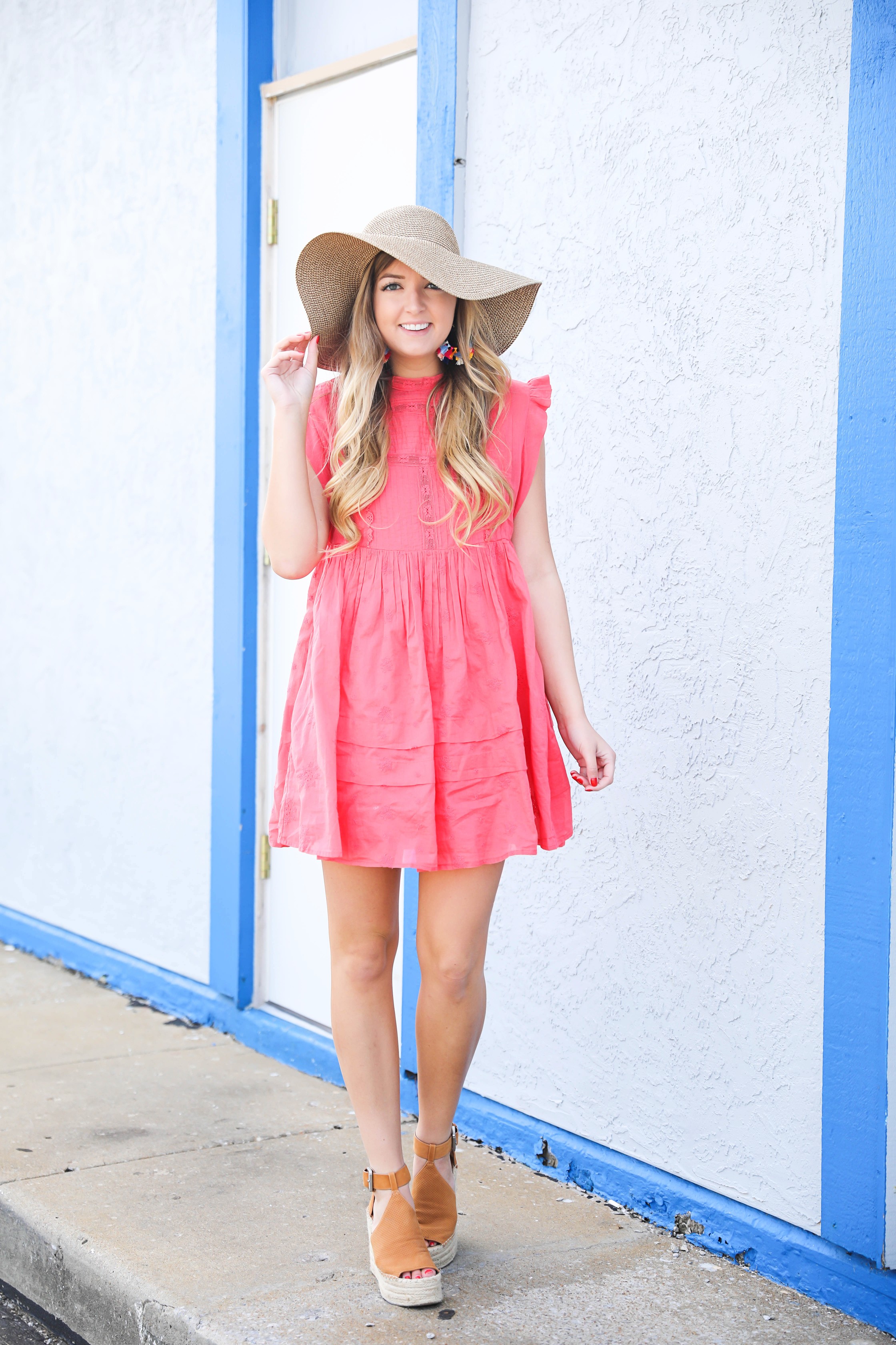 Coral babydoll dress by free people with floppy hat and bright tassel baublebar earrings! I love this outfit, it gives off Caribbean vibes because it is such a bright outfit! Details on fashion blog daily dose of charm by lauren lindmark