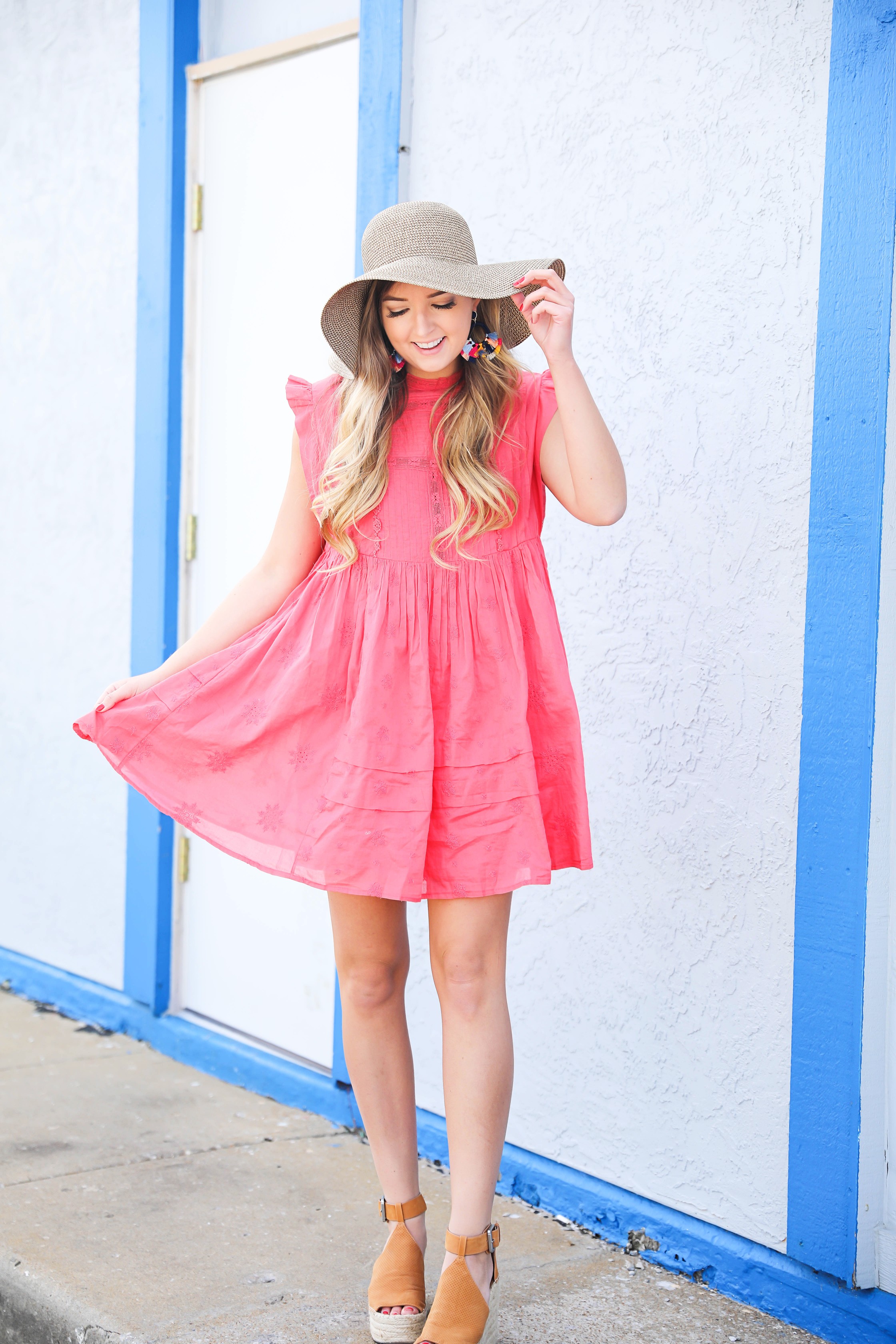 Coral babydoll dress by free people with floppy hat and bright tassel baublebar earrings! I love this outfit, it gives off Caribbean vibes because it is such a bright outfit! Details on fashion blog daily dose of charm by lauren lindmark