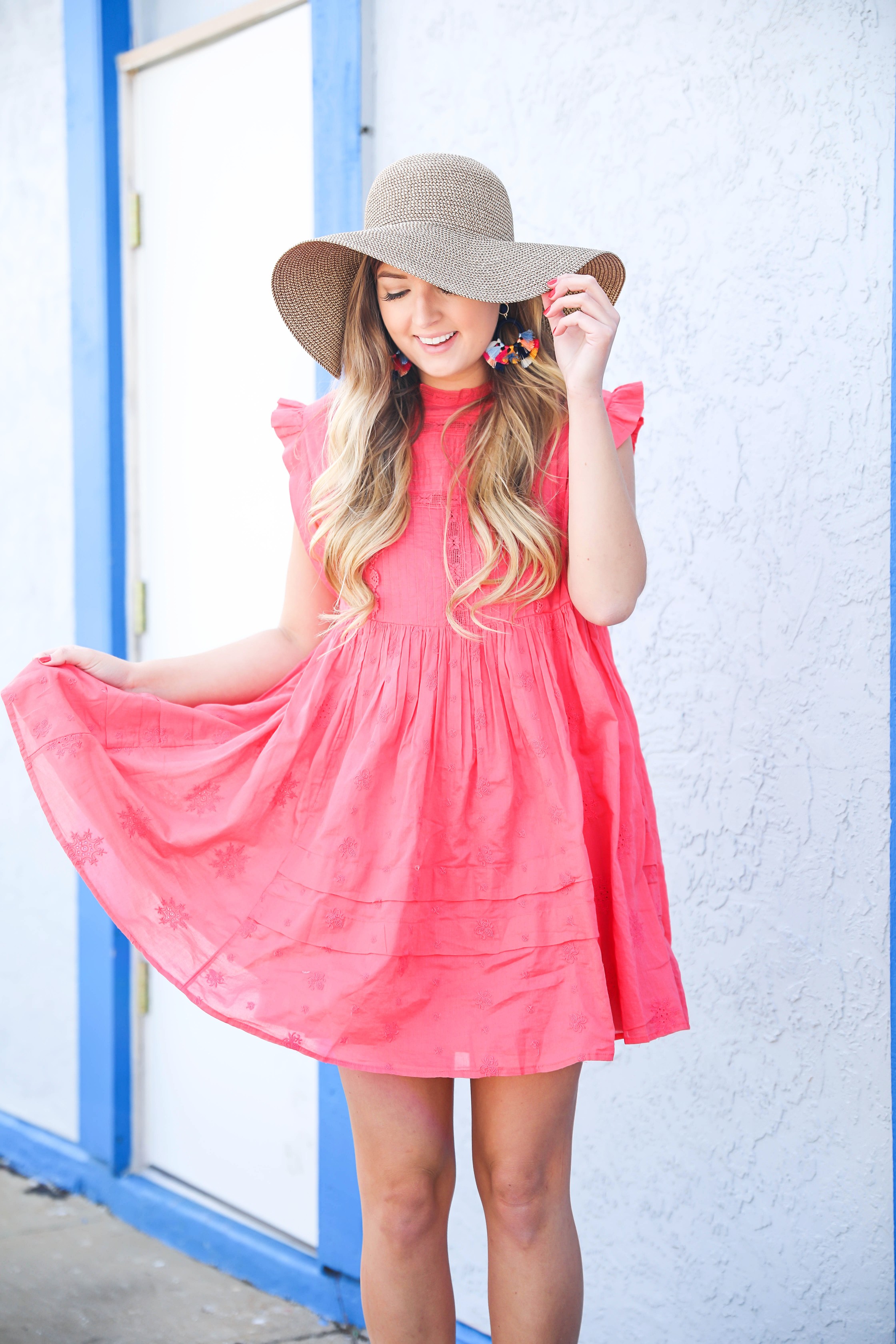 Coral babydoll dress by free people with floppy hat and bright tassel baublebar earrings! I love this outfit, it gives off Caribbean vibes because it is such a bright outfit! Details on fashion blog daily dose of charm by lauren lindmark