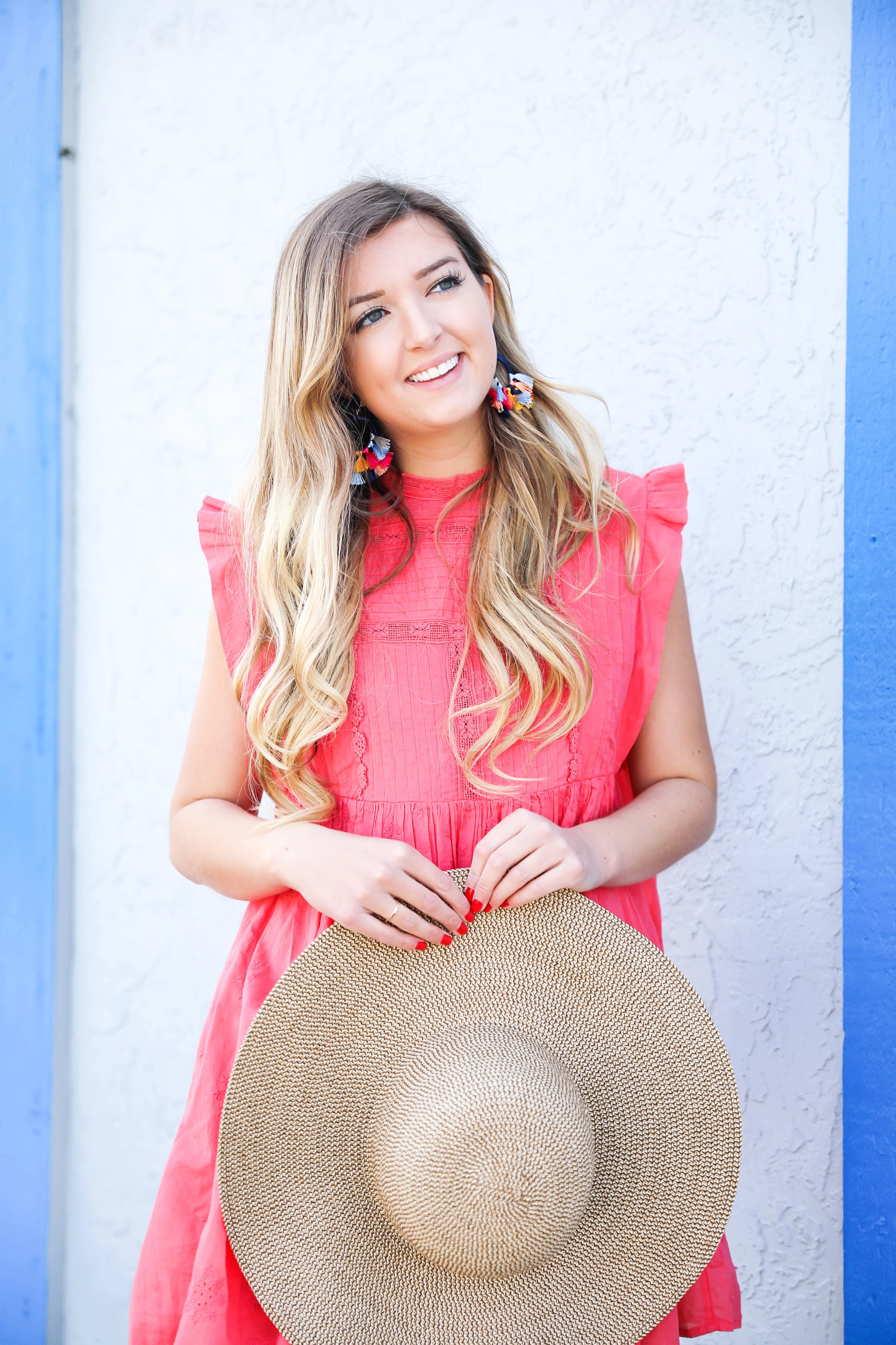 Coral babydoll dress by free people with floppy hat and bright tassel baublebar earrings! I love this outfit, it gives off Caribbean vibes because it is such a bright outfit! Details on fashion blog daily dose of charm by lauren lindmark