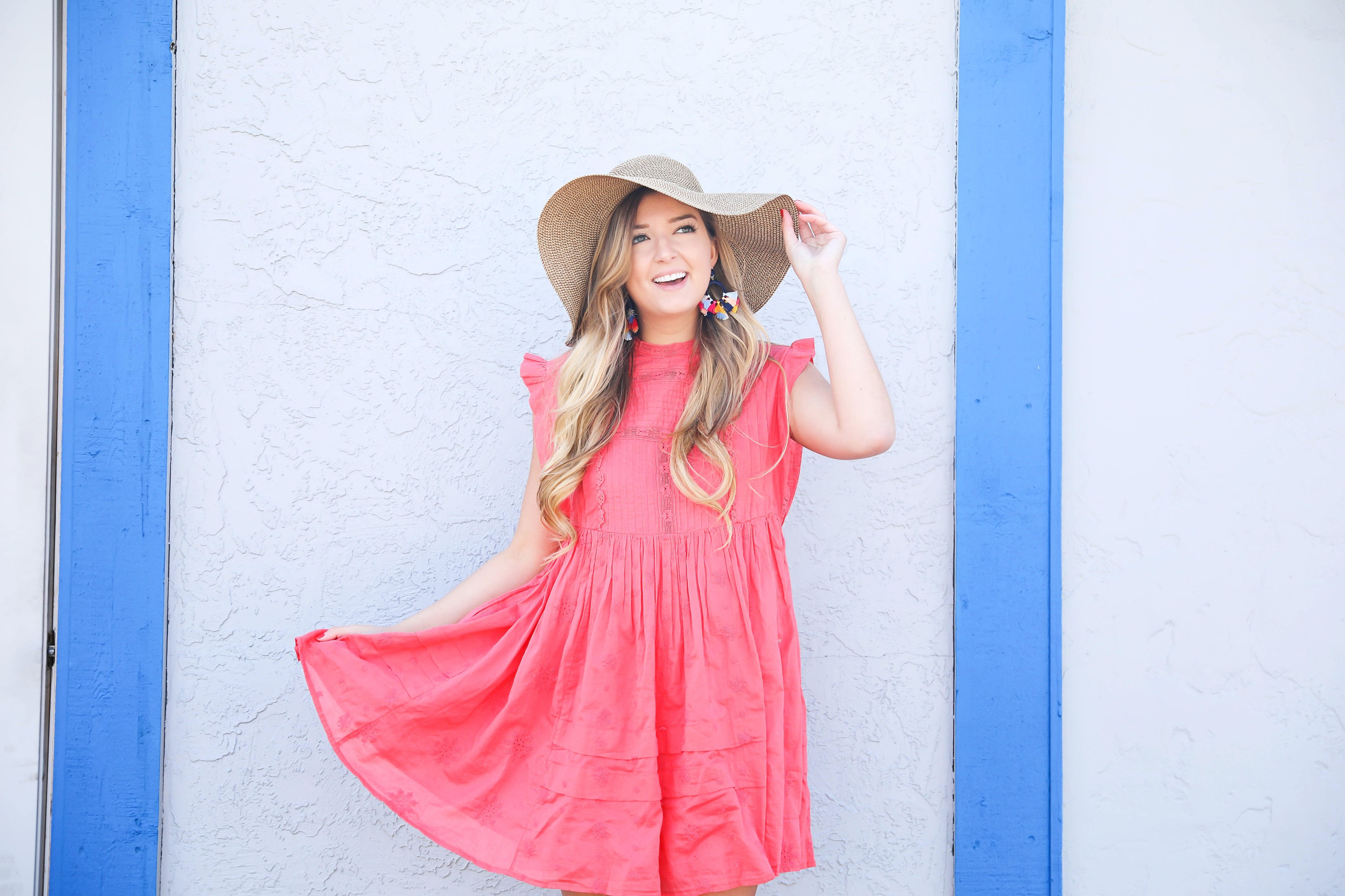 Coral babydoll dress by free people with floppy hat and bright tassel baublebar earrings! I love this outfit, it gives off Caribbean vibes because it is such a bright outfit! Details on fashion blog daily dose of charm by lauren lindmark