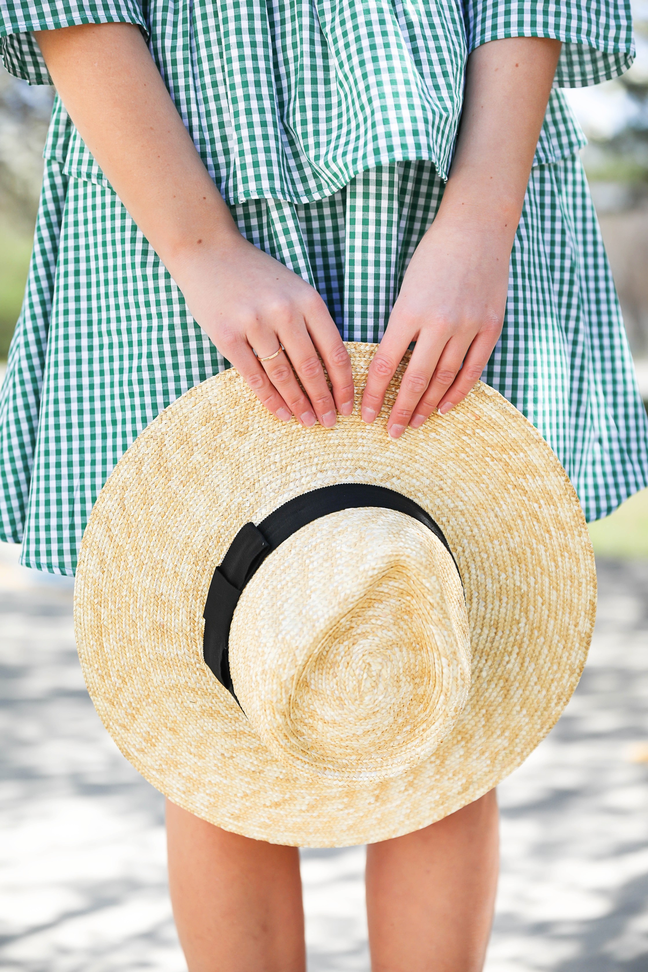 Green gingham dress perfect for spring days or days on the beach! I paired it with a straw hat and blue earrings! The most beautiful spring blooming trees were in the background making this spring fashion look perfection! Details on fashion blog daily dose of charm by lauren lindmark