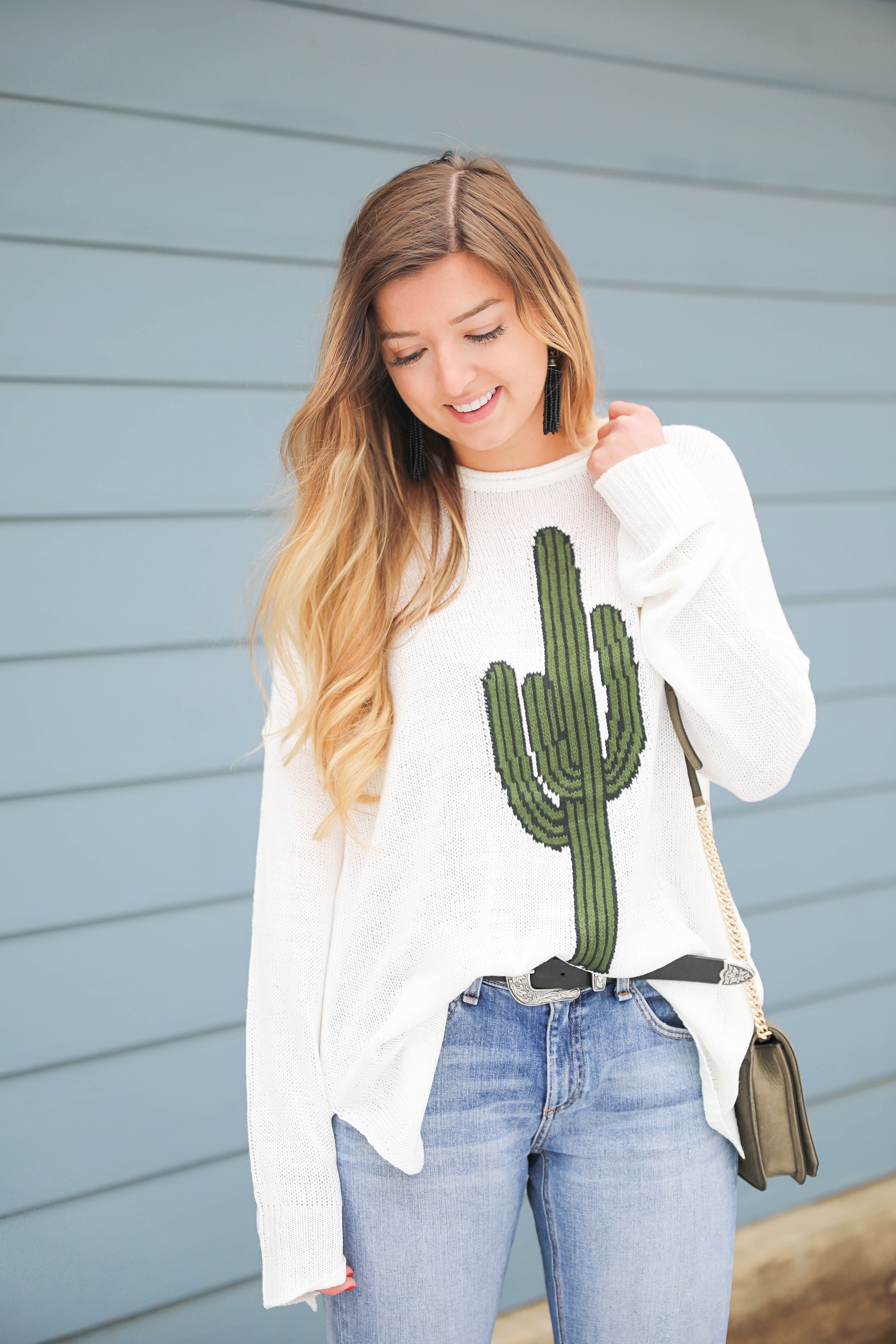 Super cute cactus sweater for spring and summer! This sweater is by Show Me Your Mumu. I love their spring cactus line, but this cactus sweater is my favorite! I paired it with booties, a black belt, and a Rebecca Minkoff bag! Perfect spring outfit inspiration on fashion blog daily dose of charm by lauren lindmark