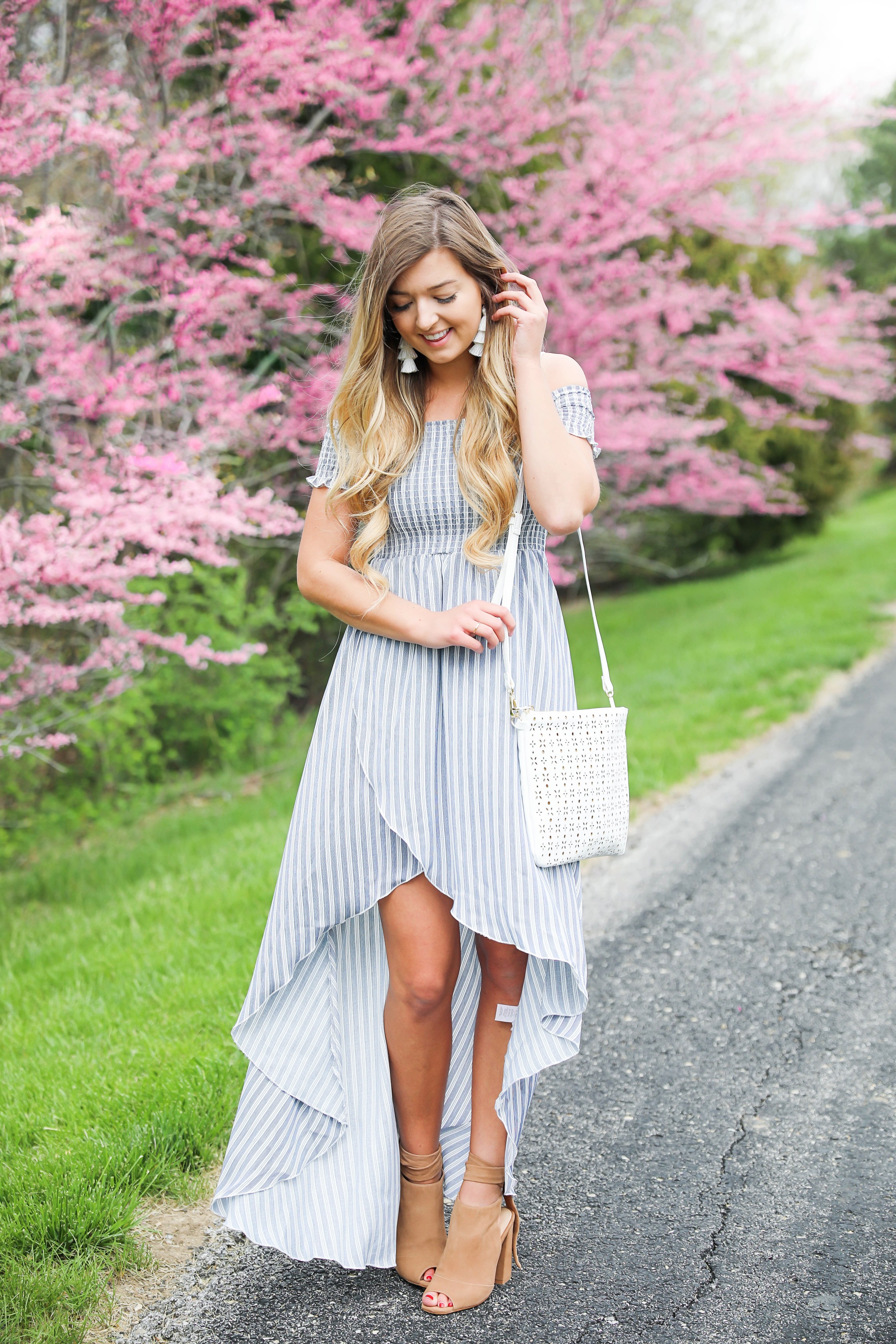 Show me your mumu striped high low maxi dress! Paired with adorable tie up heels and tassel earrings! Springy pink flower trees tie together this whole photoshoot! Check out this spring outfit on fashion blog daily dose of charm by Lauren Lindmark