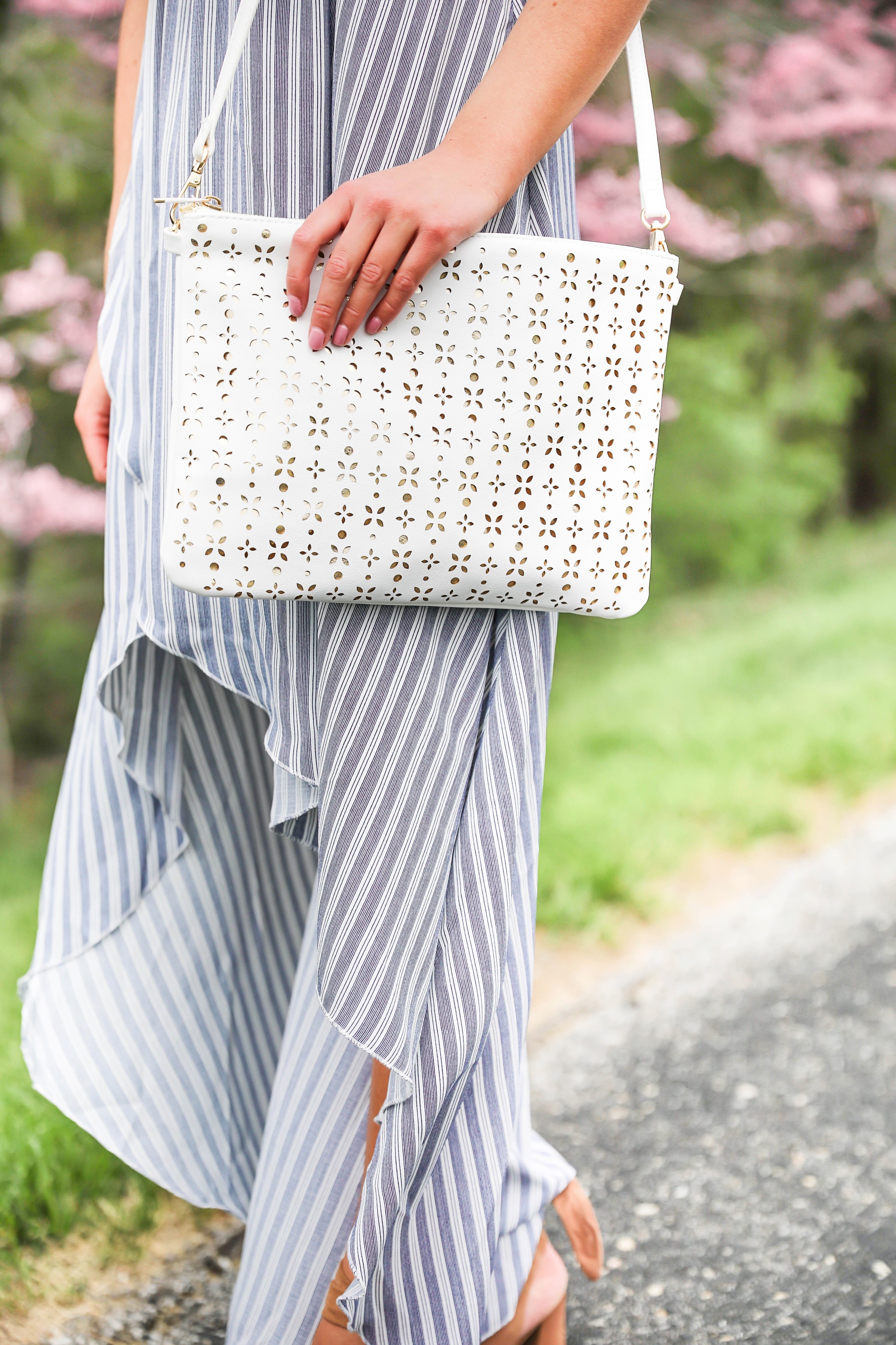 Show me your mumu striped high low maxi dress! Paired with adorable tie up heels and tassel earrings! Springy pink flower trees tie together this whole photoshoot! Check out this spring outfit on fashion blog daily dose of charm by Lauren Lindmark