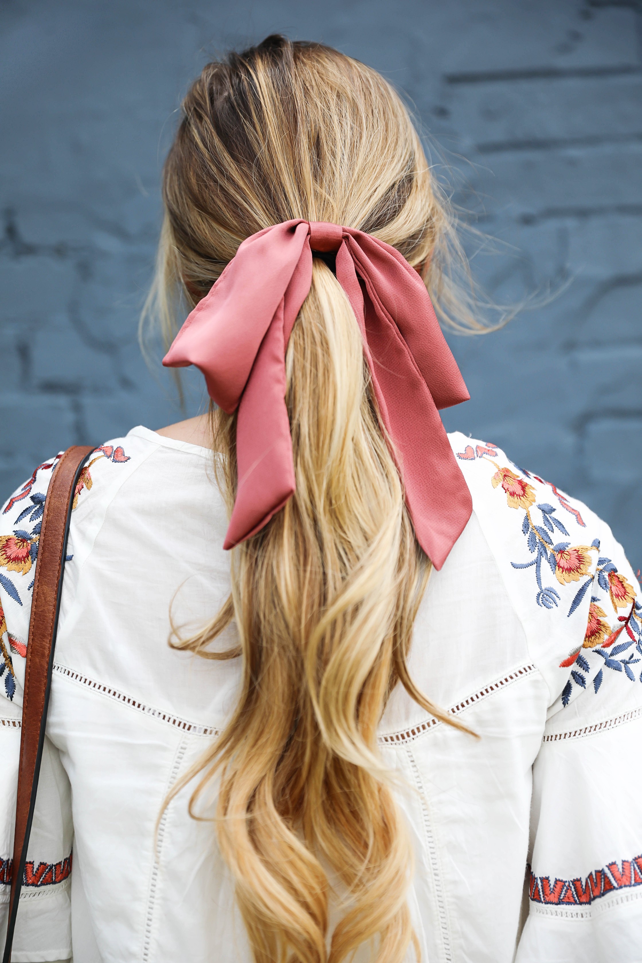 Free People embrodiered white dress for summer! I paired this adorable summer dress with a mauve hair bow and saddle bag by sole society! I love my hair in a ponytail with a bow, hair scarves are so in right now! Details on fashion blog by daily dose of charm by lauren lindmark