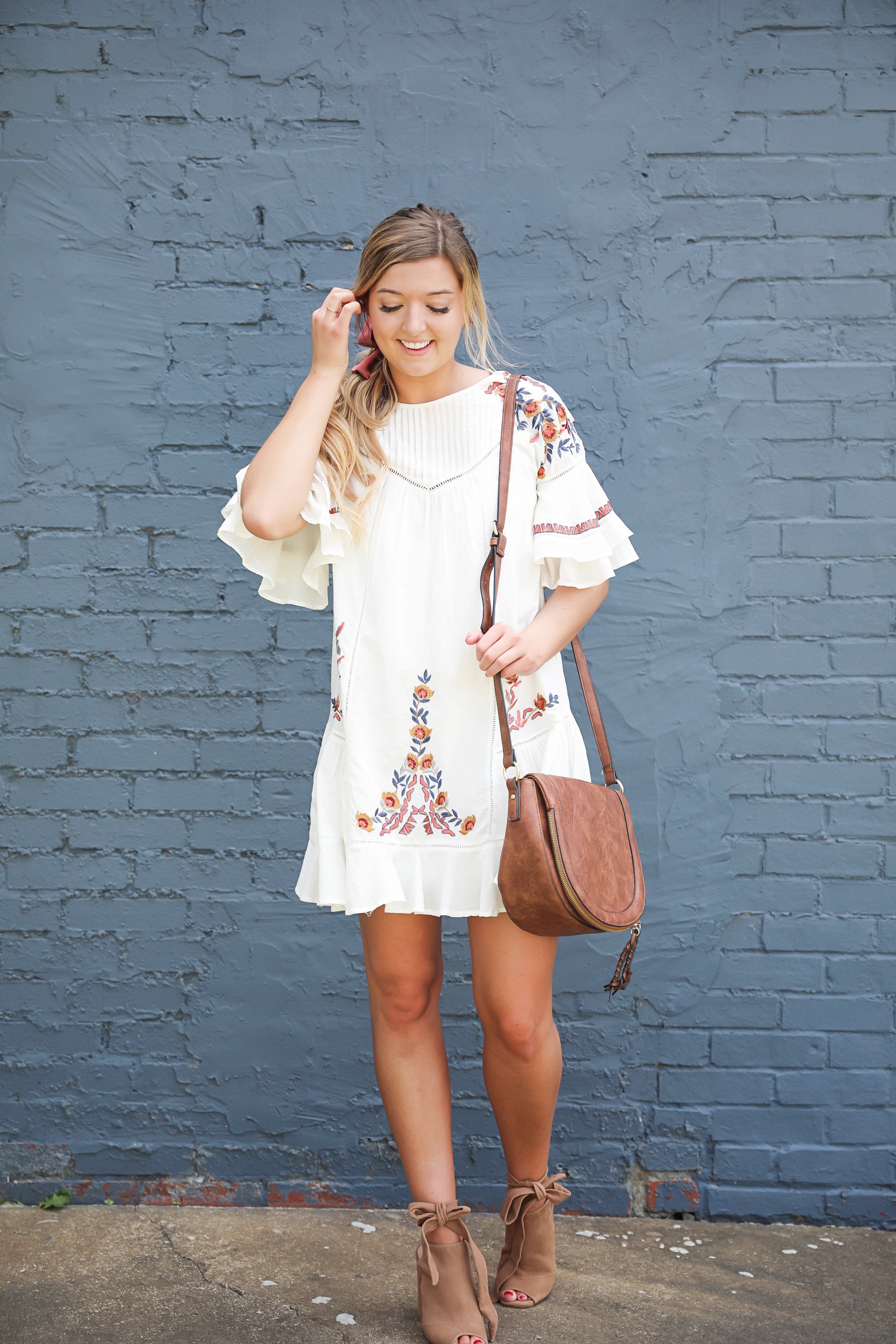 Free People embrodiered white dress for summer! I paired this adorable summer dress with a mauve hair bow and saddle bag by sole society! I love my hair in a ponytail with a bow, hair scarves are so in right now! Details on fashion blog by daily dose of charm by lauren lindmark