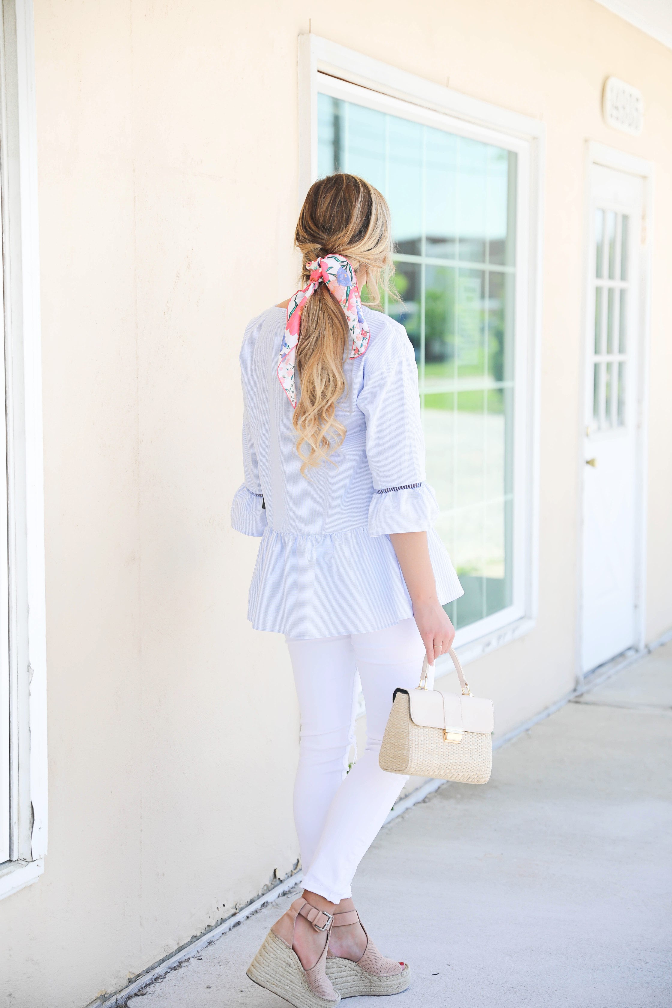 Seersucker peplum top from the Blue Door Boutique paired with white jeans and cute wedges! I love this preppy look, this kate spade silk scarf I super in for spring! I love this spring outfit! Silk scarf hairstyle idea! I love scarves and ponytails on fashion blog daily dose of charm by lauren lindmark