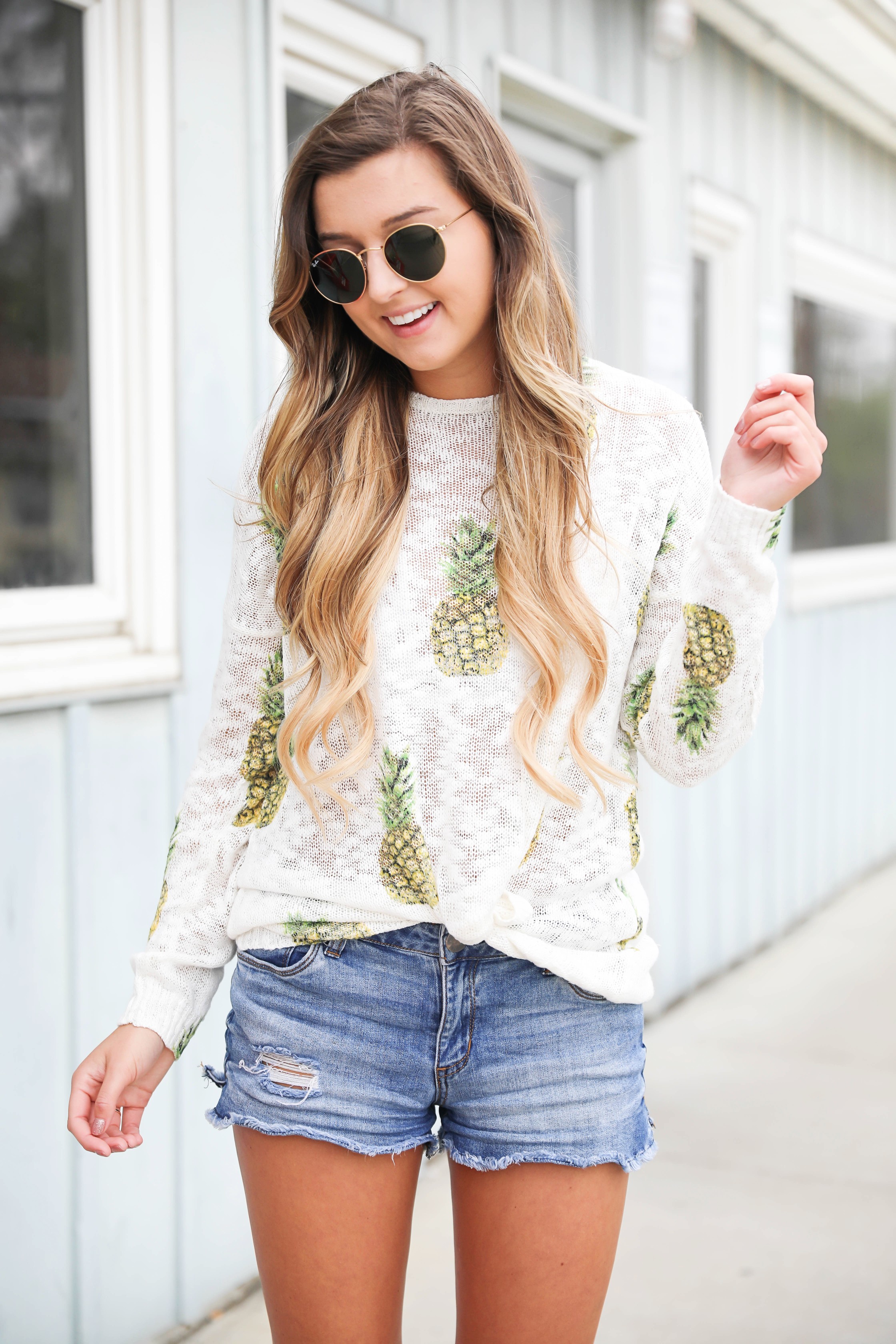 Cute pineapple sweater tucked into denim shorts for spring! Show Me Your Mumu pineapple sweater! I love this spring outfit, this adorable spring sweater is on fashion blog daily dose of charm by lauren lindmark