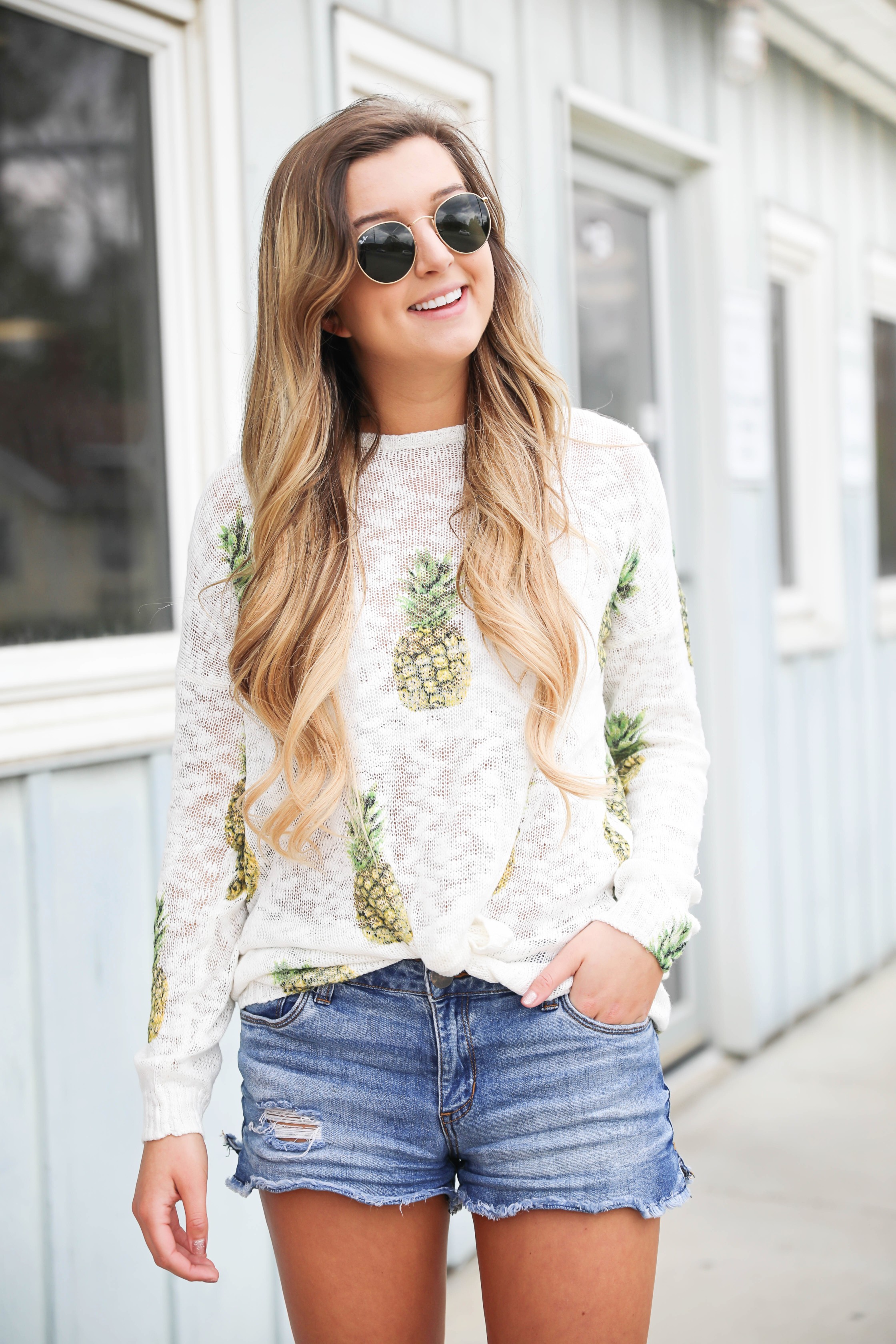 Cute pineapple sweater tucked into denim shorts for spring! Show Me Your Mumu pineapple sweater! I love this spring outfit, this adorable spring sweater is on fashion blog daily dose of charm by lauren lindmark
