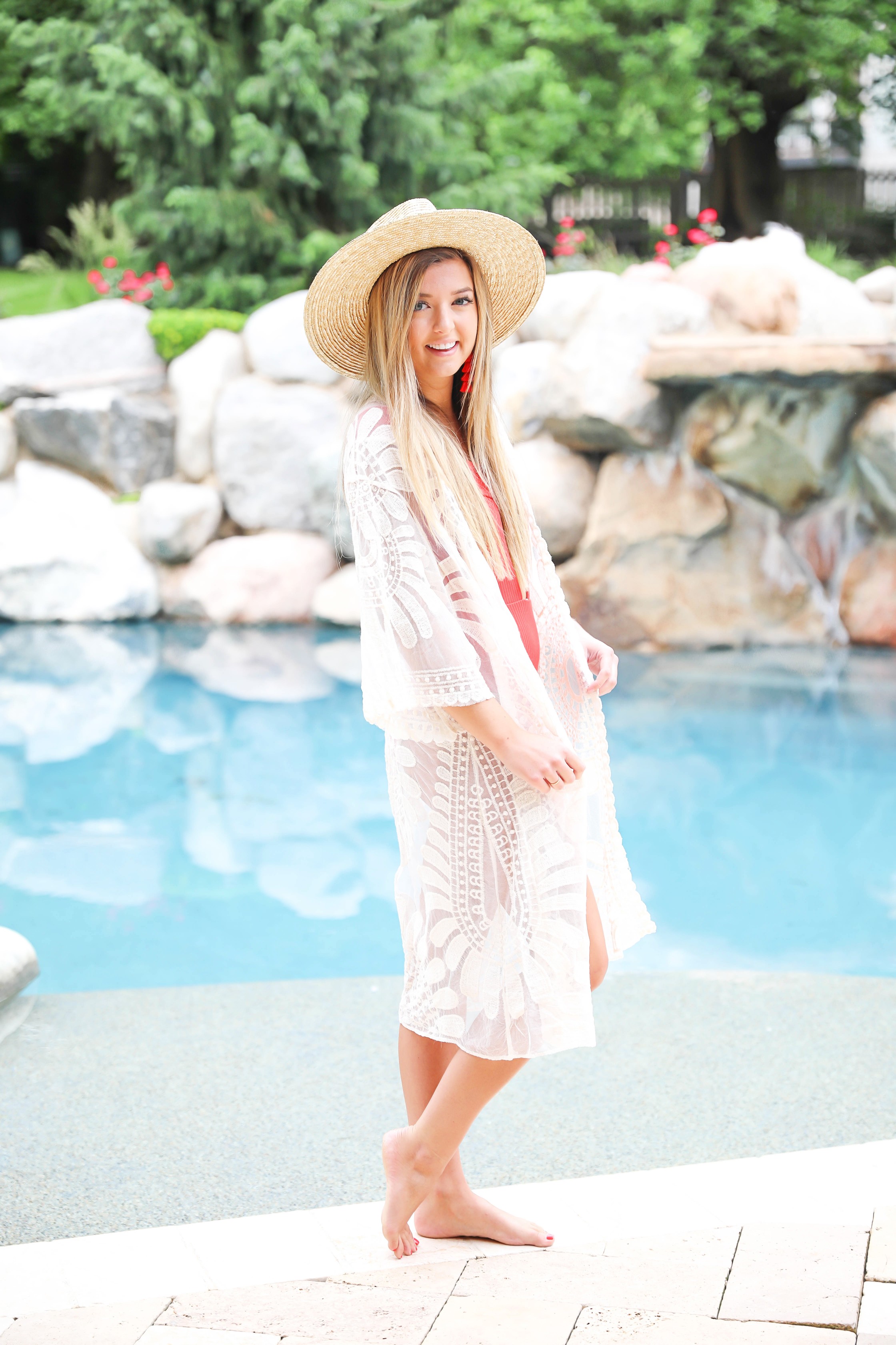 Hot red one piece! This adorable suit is reversible and also comes in white, yellow, and black! I paired this with my sheer mesh woven lace kimono and wide brim straw hat! Summer look by the pool! Details on fashion blog daily dose of charm by lauren lindmark