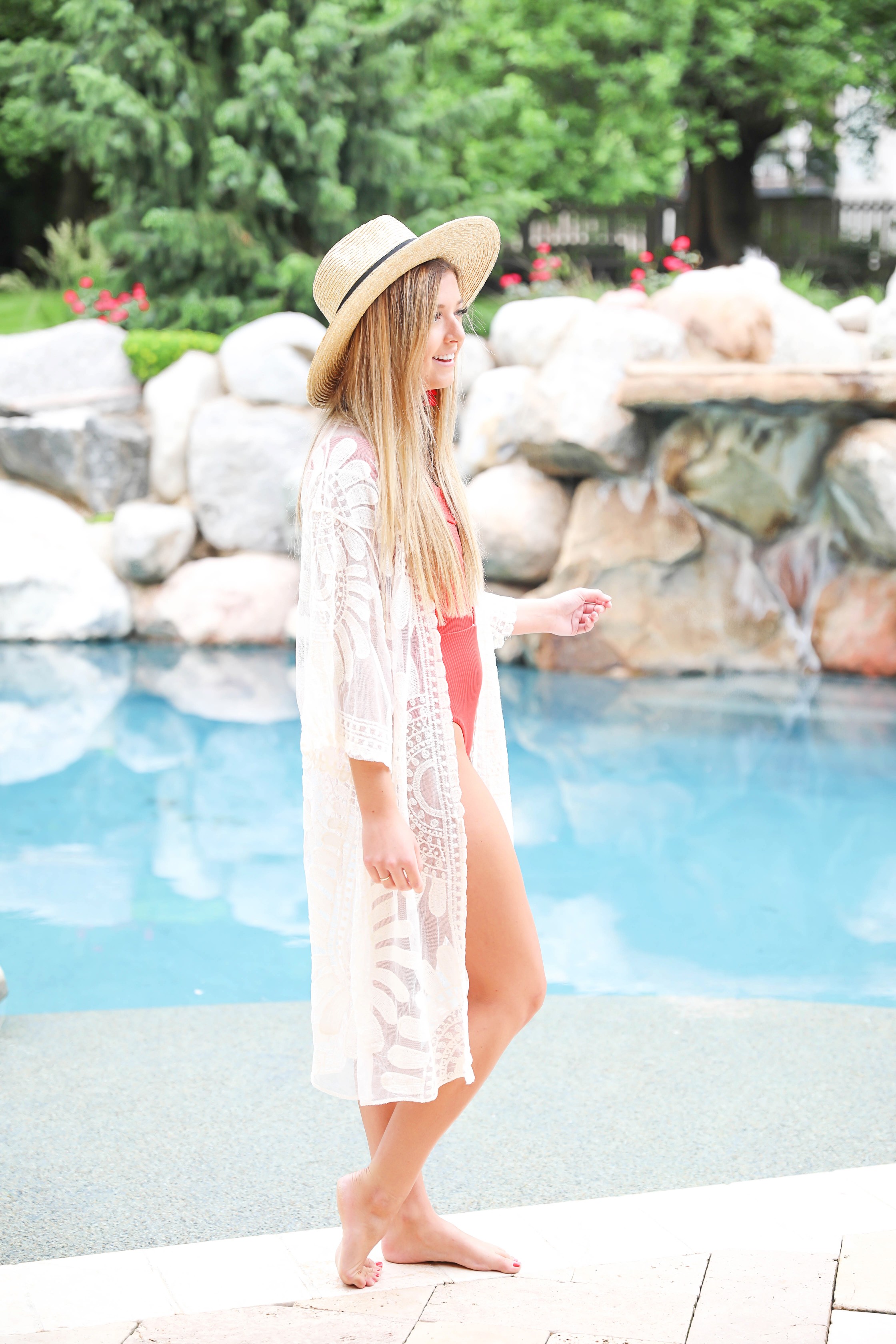 Hot red one piece! This adorable suit is reversible and also comes in white, yellow, and black! I paired this with my sheer mesh woven lace kimono and wide brim straw hat! Summer look by the pool! Details on fashion blog daily dose of charm by lauren lindmark