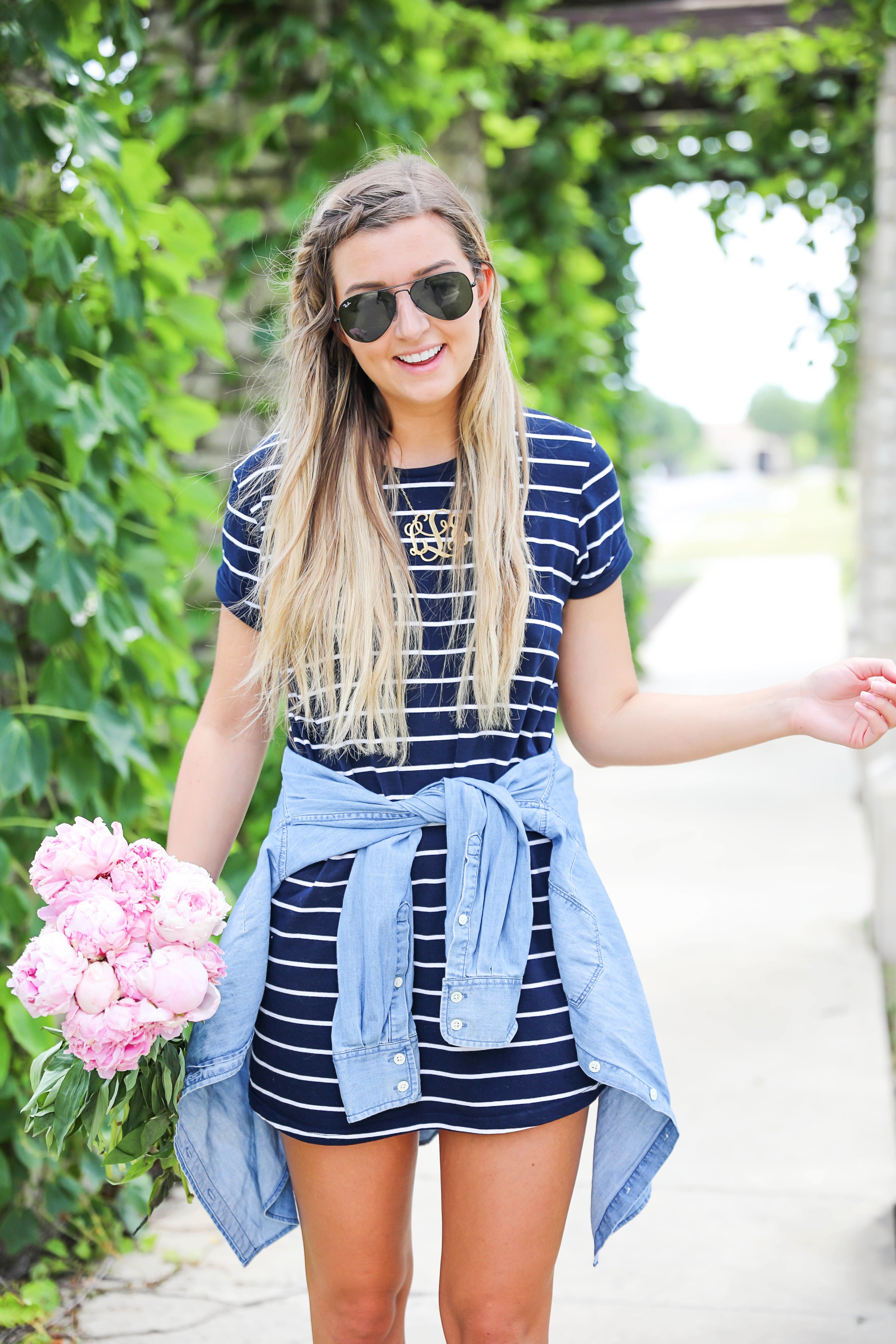 Striped t-shirt dress with a jean jacket tied around my waist! I love these pink peonies in the summer so they made the perfect "accessory" to this look! I finished the outfit with my braided suede shoes and large gold monogram necklace! Plus my new favorite Ray Ban black aviators! Details on this summer outfit are on fashion blog daily dose of charm by lauren lindmark