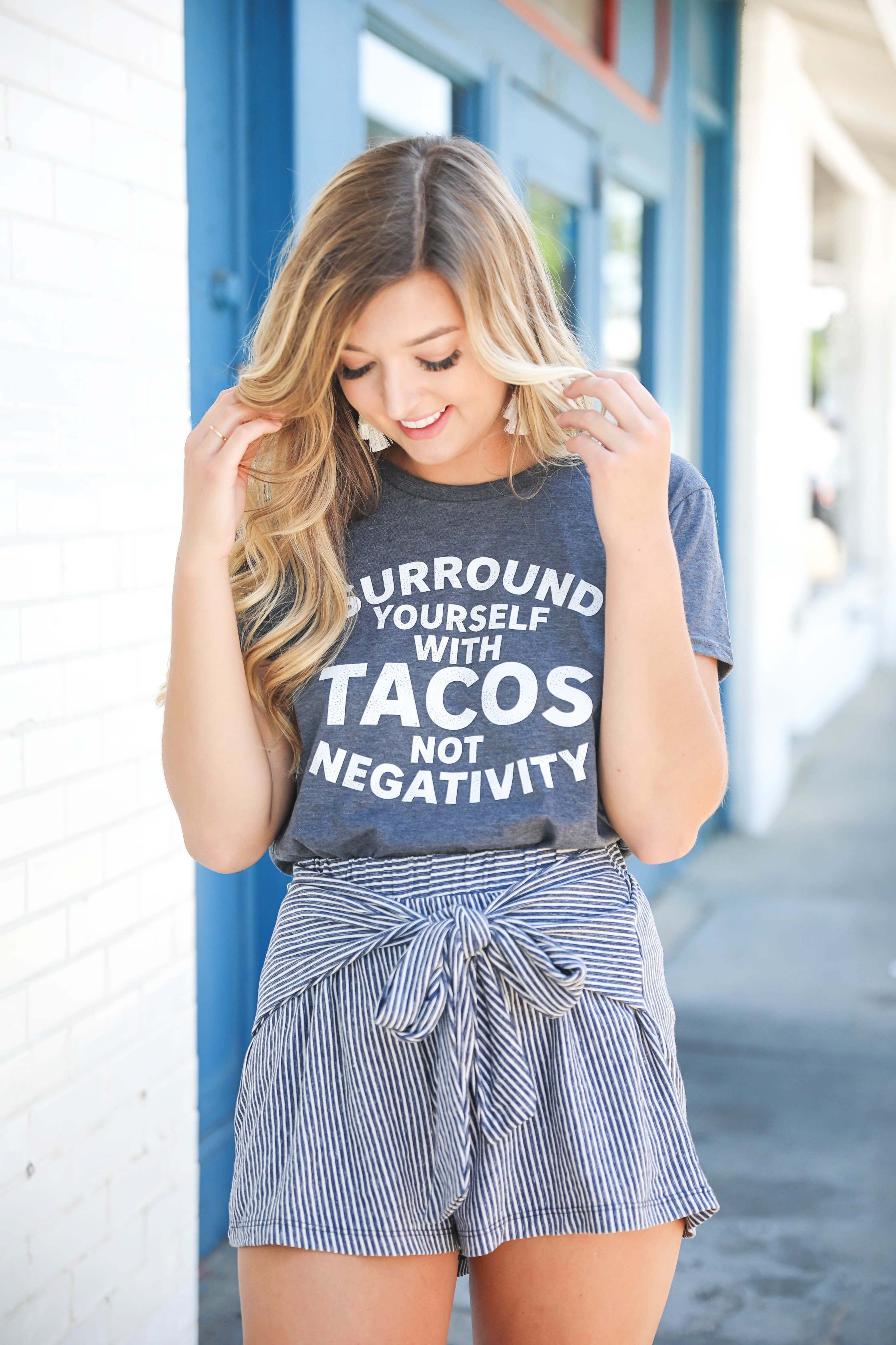 Surround yourself with tacos, not negativity. This is the cutest taco tee! I have been loving for a cute taco tshirt and this one is adorable with my striped cotton shorts! Tied shorts are so in right now! Summer fashion details on the blog daily dose of charm by lauren lindmark