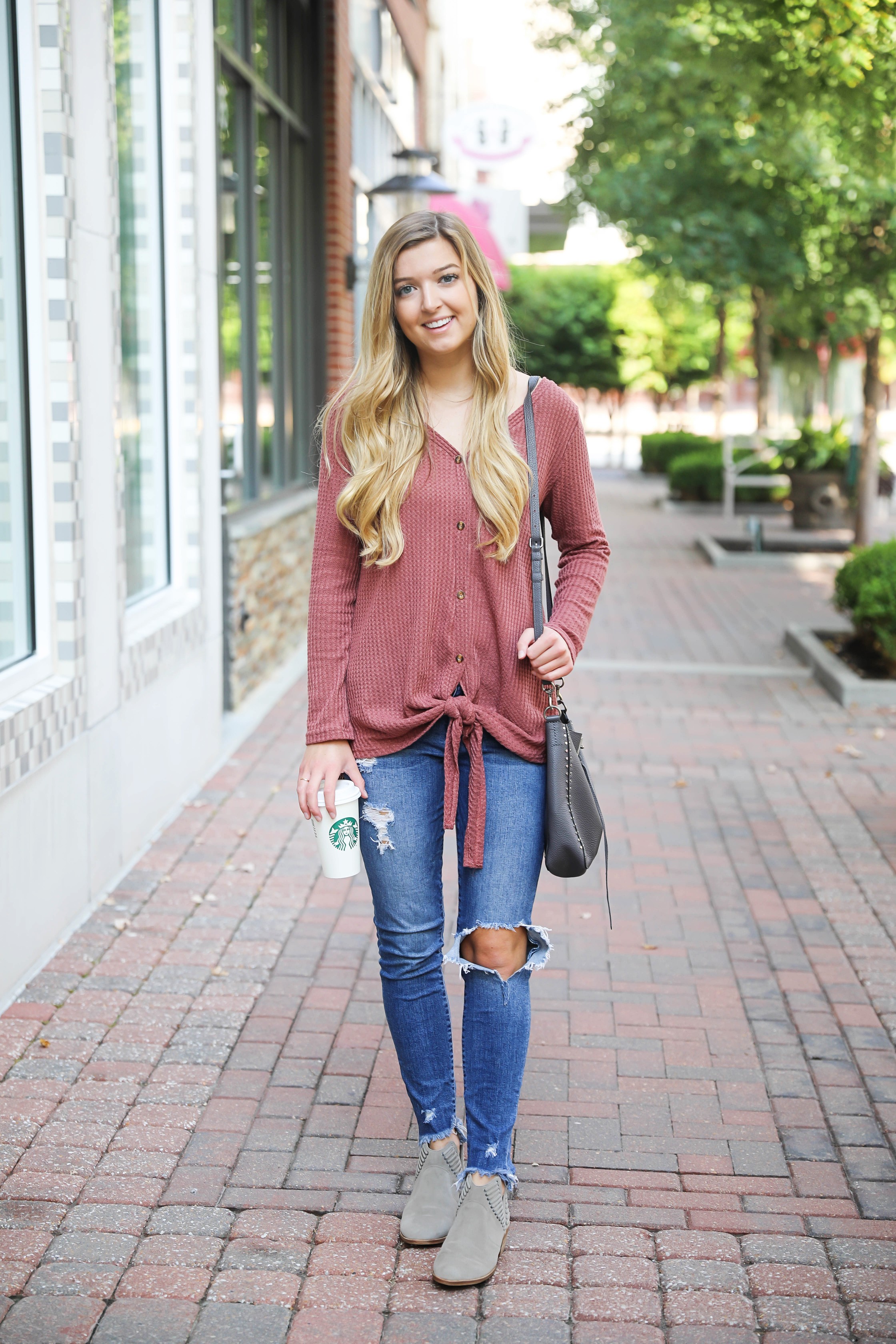 Burgundy waffle top! These waffle tops are all the rage, I love when they are tied on the end! It comes in a ton of cute fall colors. I paired mine with ripped denim jeans and this cute Rebecca Minkoff purse! Such a cute fall outfit for back to school! Details on fashion blog daily dose of charm by lauren lindmark