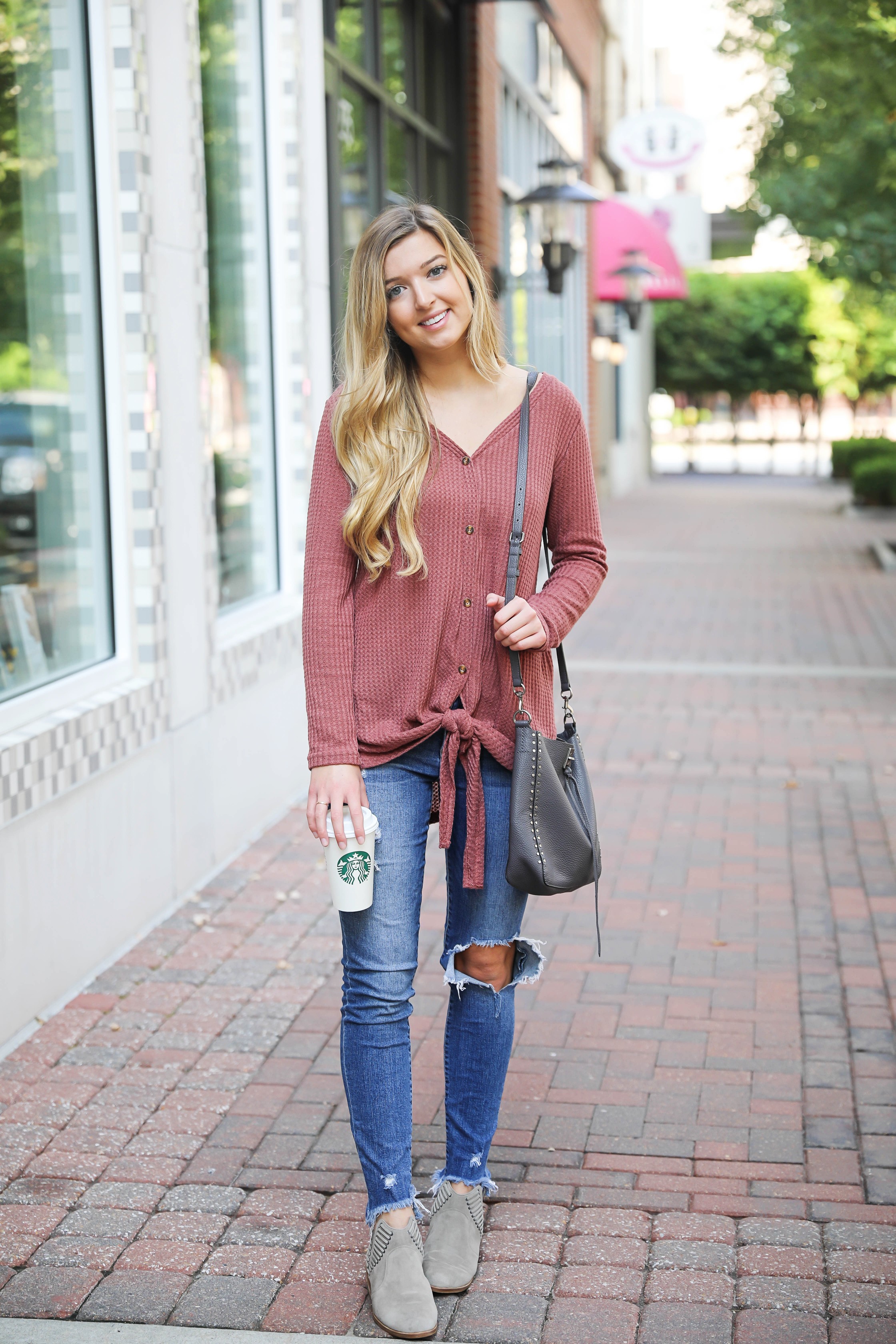 Burgundy waffle top! These waffle tops are all the rage, I love when they are tied on the end! It comes in a ton of cute fall colors. I paired mine with ripped denim jeans and this cute Rebecca Minkoff purse! Such a cute fall outfit for back to school! Details on fashion blog daily dose of charm by lauren lindmark