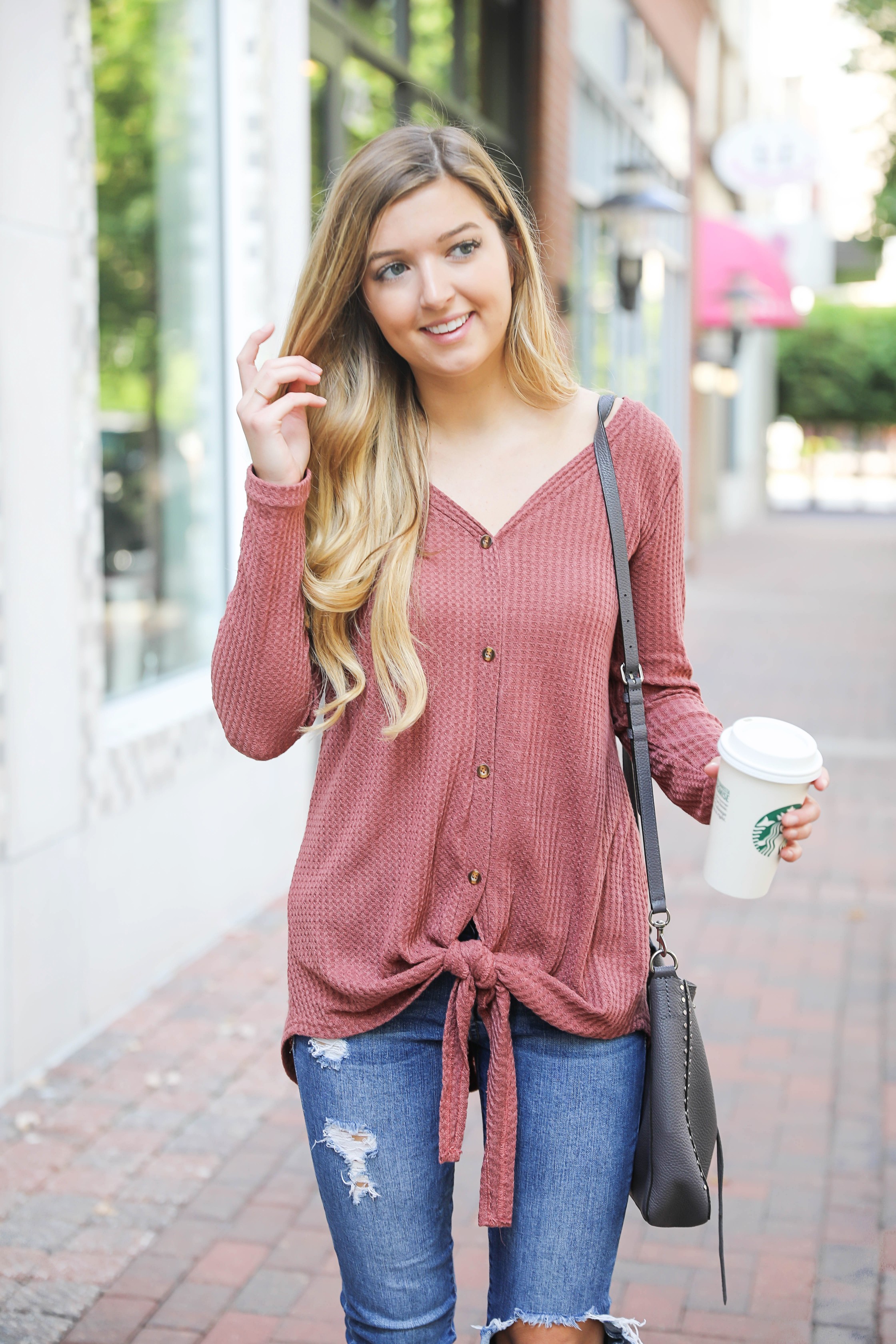 Burgundy waffle top! These waffle tops are all the rage, I love when they are tied on the end! It comes in a ton of cute fall colors. I paired mine with ripped denim jeans and this cute Rebecca Minkoff purse! Such a cute fall outfit for back to school! Details on fashion blog daily dose of charm by lauren lindmark