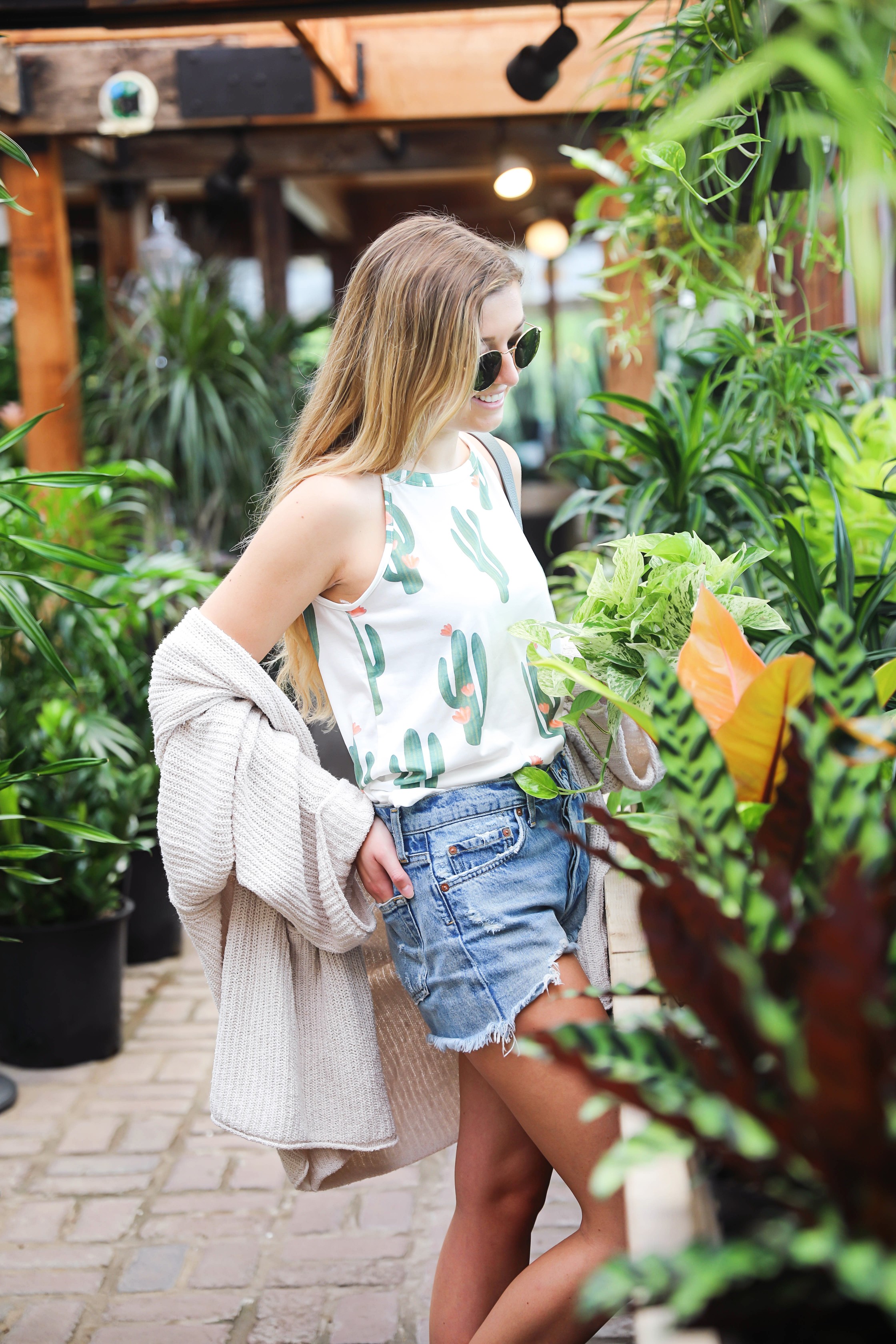 Cutest cactus top! Not only is it adorable, but it's inexpensive! I paired them with jean shorts, my favorite cream free people cardigan, my new allsaints bag, Tory Burch Millers, and Ray Ban sunglasses! The cutest summer outfit shot at a flower and plant nursery! Details on fashion blog daily dose of charm by lauren lindmark