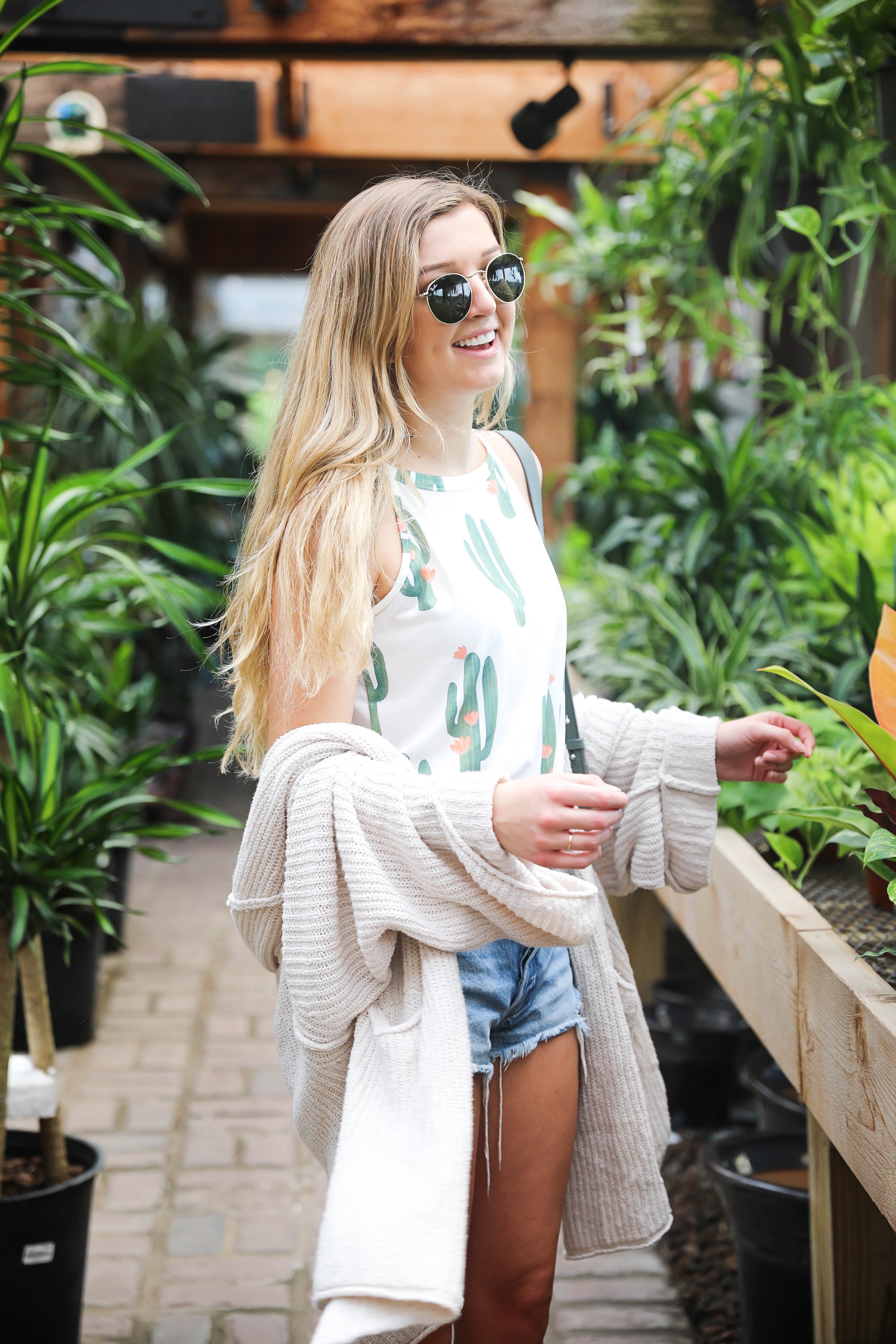 Cutest cactus top! Not only is it adorable, but it's inexpensive! I paired them with jean shorts, my favorite cream free people cardigan, my new allsaints bag, Tory Burch Millers, and Ray Ban sunglasses! The cutest summer outfit shot at a flower and plant nursery! Details on fashion blog daily dose of charm by lauren lindmark