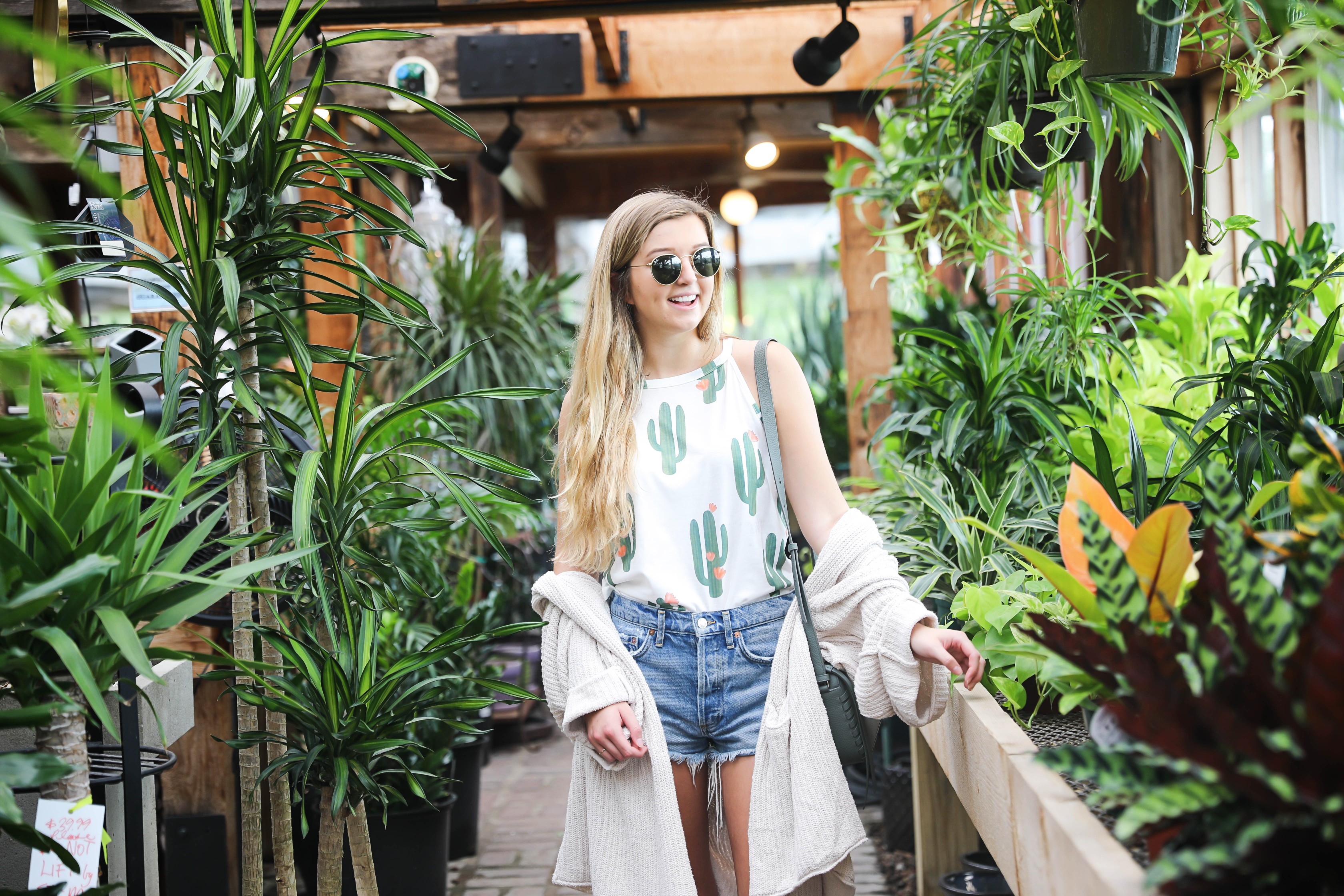 Cutest cactus top! Not only is it adorable, but it's inexpensive! I paired them with jean shorts, my favorite cream free people cardigan, my new allsaints bag, Tory Burch Millers, and Ray Ban sunglasses! The cutest summer outfit shot at a flower and plant nursery! Details on fashion blog daily dose of charm by lauren lindmark