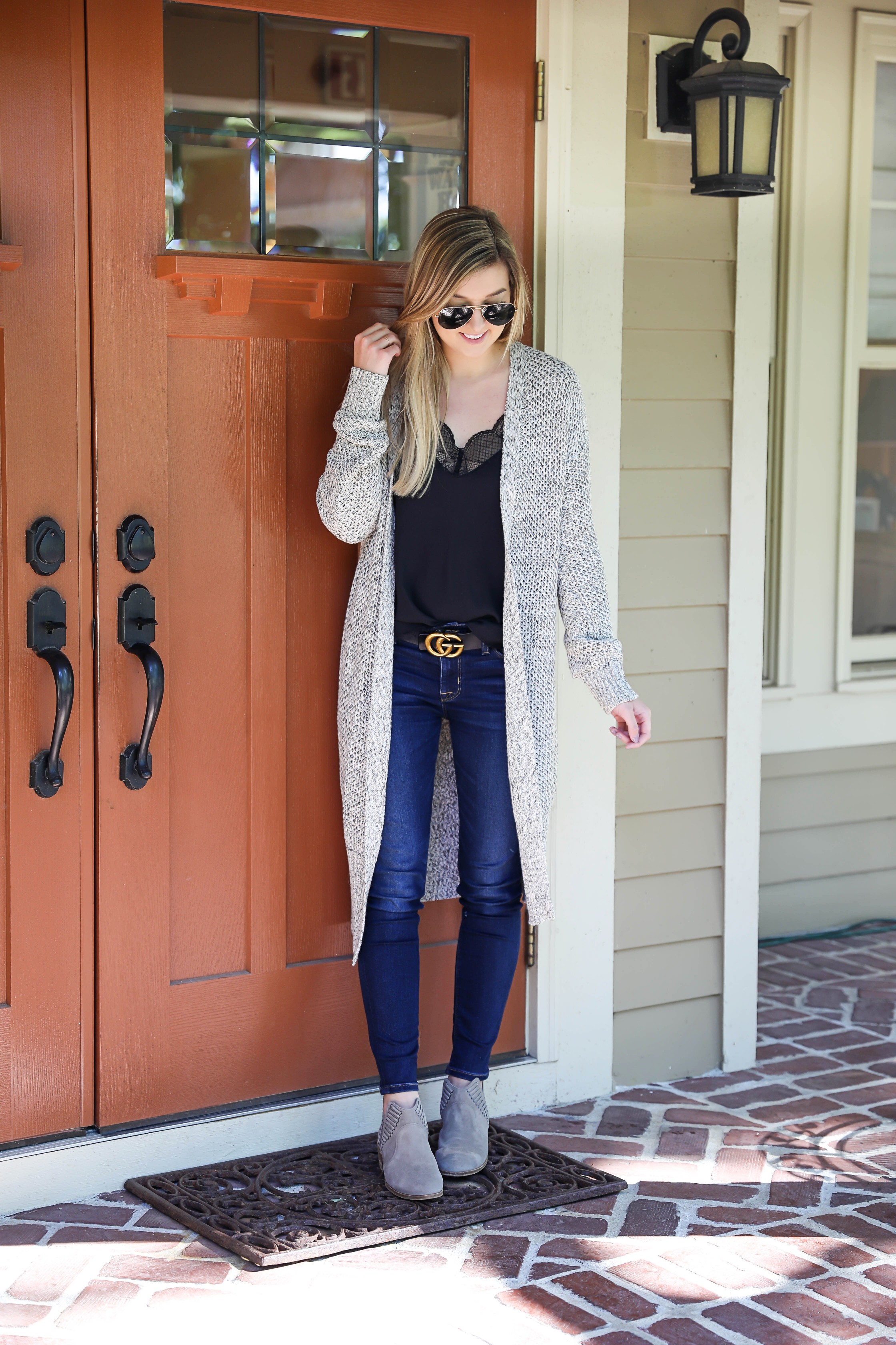 Black cami with long grery knitted duster! Perfect fall outfit paired with a cute gucci belt and dark denim jeans! I am also wearing my vince camuto booties that I love for autumn! Details on fashion blog daily dose of charm by lauren lindmark