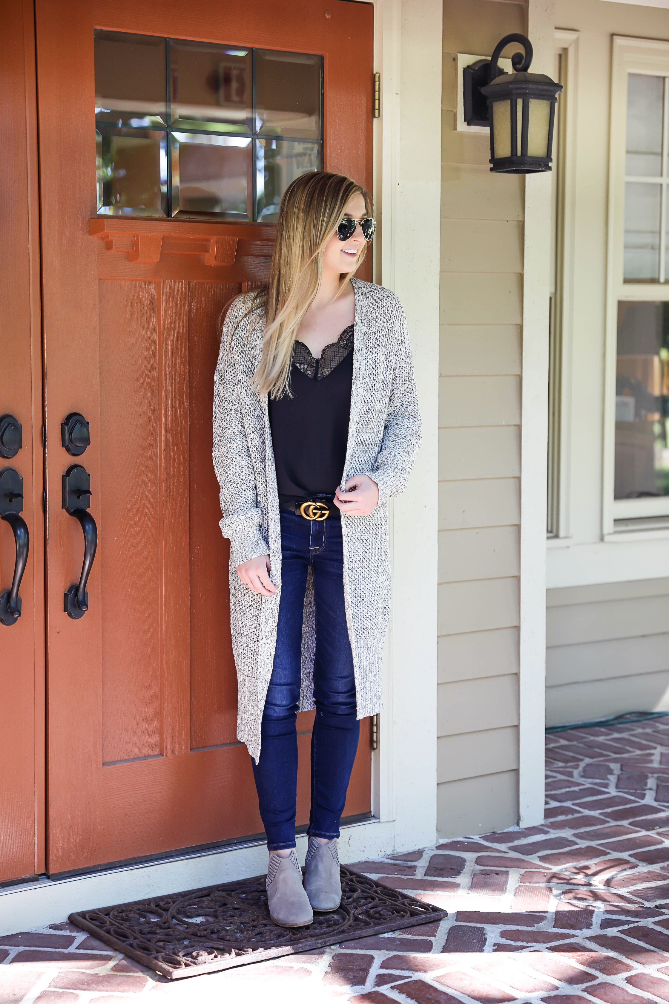 Black cami with long grery knitted duster! Perfect fall outfit paired with a cute gucci belt and dark denim jeans! I am also wearing my vince camuto booties that I love for autumn! Details on fashion blog daily dose of charm by lauren lindmark
