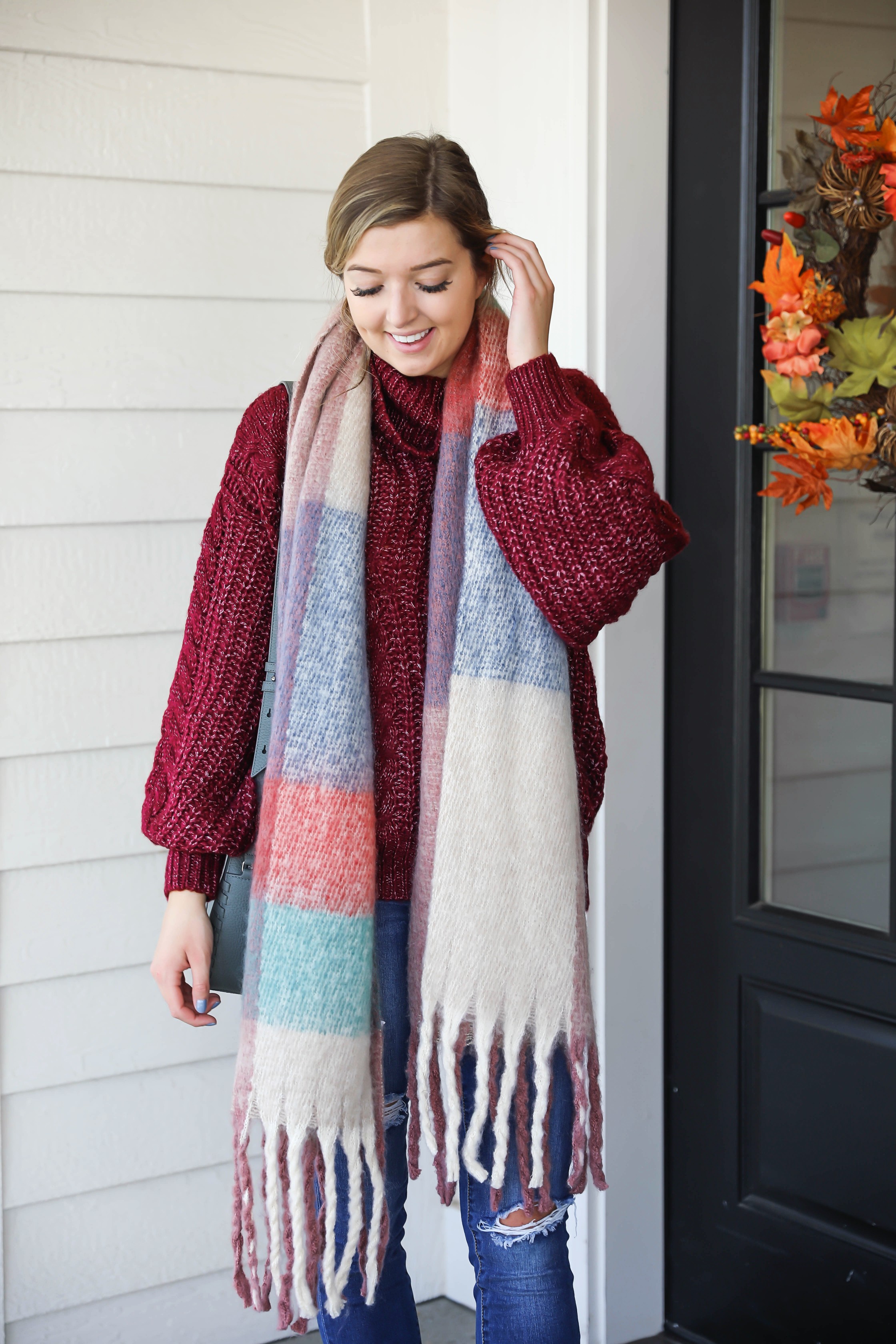 Burgundy knit sweater with the softest plaid oversized scarf! Paired with ripped denim jeans and my vince camuto booties! This is the perfect fall outfit you need in your closet! A few pieces are from Red Dress Boutique which is the best online store, especially for fall clothes! Details on fashion blog daily dose of charm by lauren lindmark