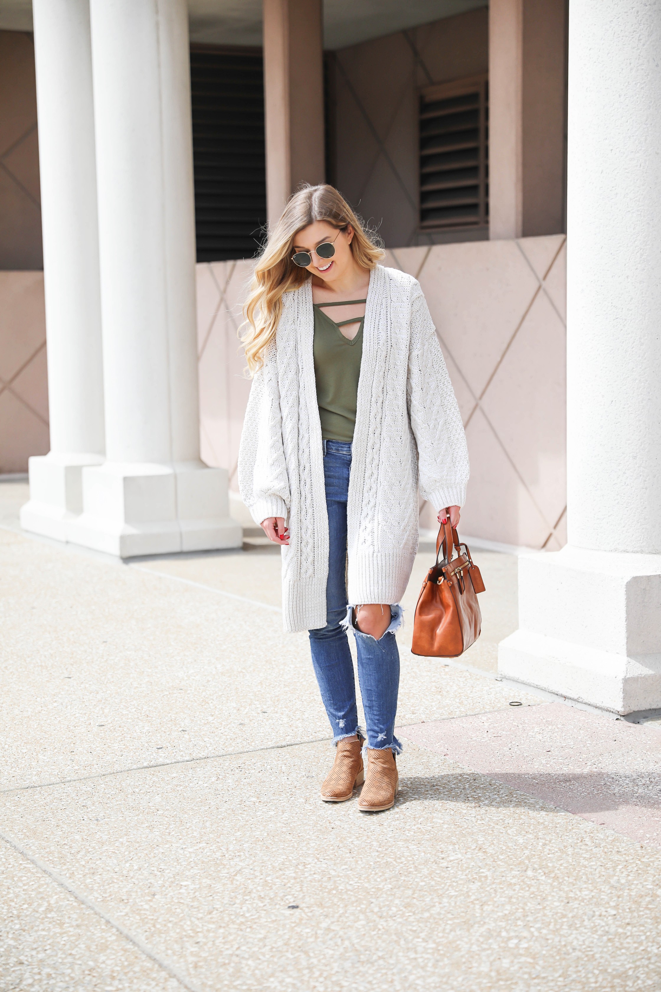 Long cream knit cardigan with a fun olive tank! Paired with my favorite ripped jeans and this super cute faux leather sole society bag that's perfect for fall! These are also the best booties for fall! Details on fashion blog daily dose of charm by Lauren Lindmark