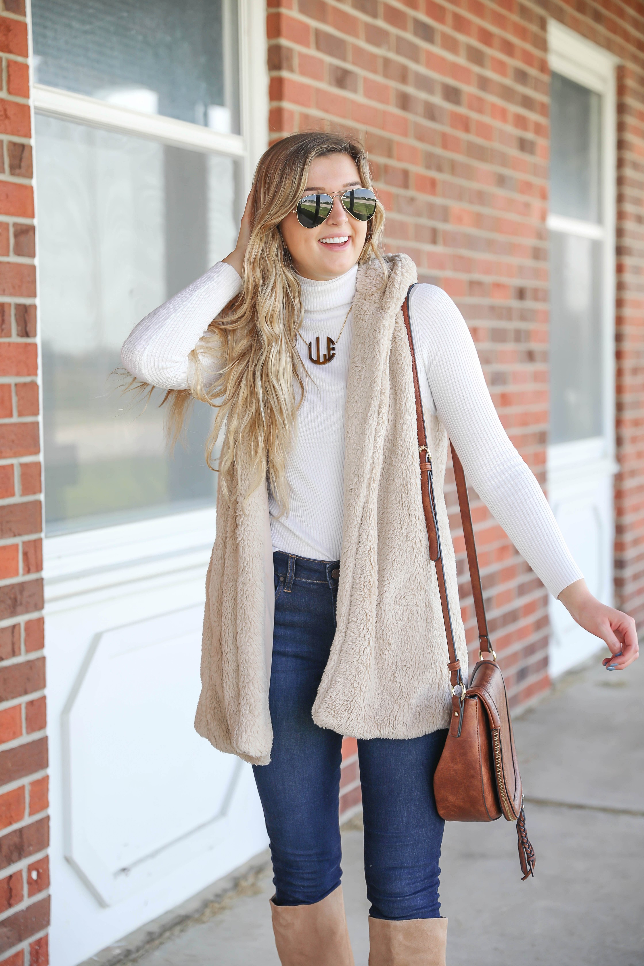 Teddy bear vest for fall! I love soft clothing and this long vest makes for the perfect fall outfit! I paired with a cute white turtleneck and monogram necklace! Plus my favorite shoes for fall are these tan sam edelman boots! Details on fashion blog daily dose of charm by lauren lindmark