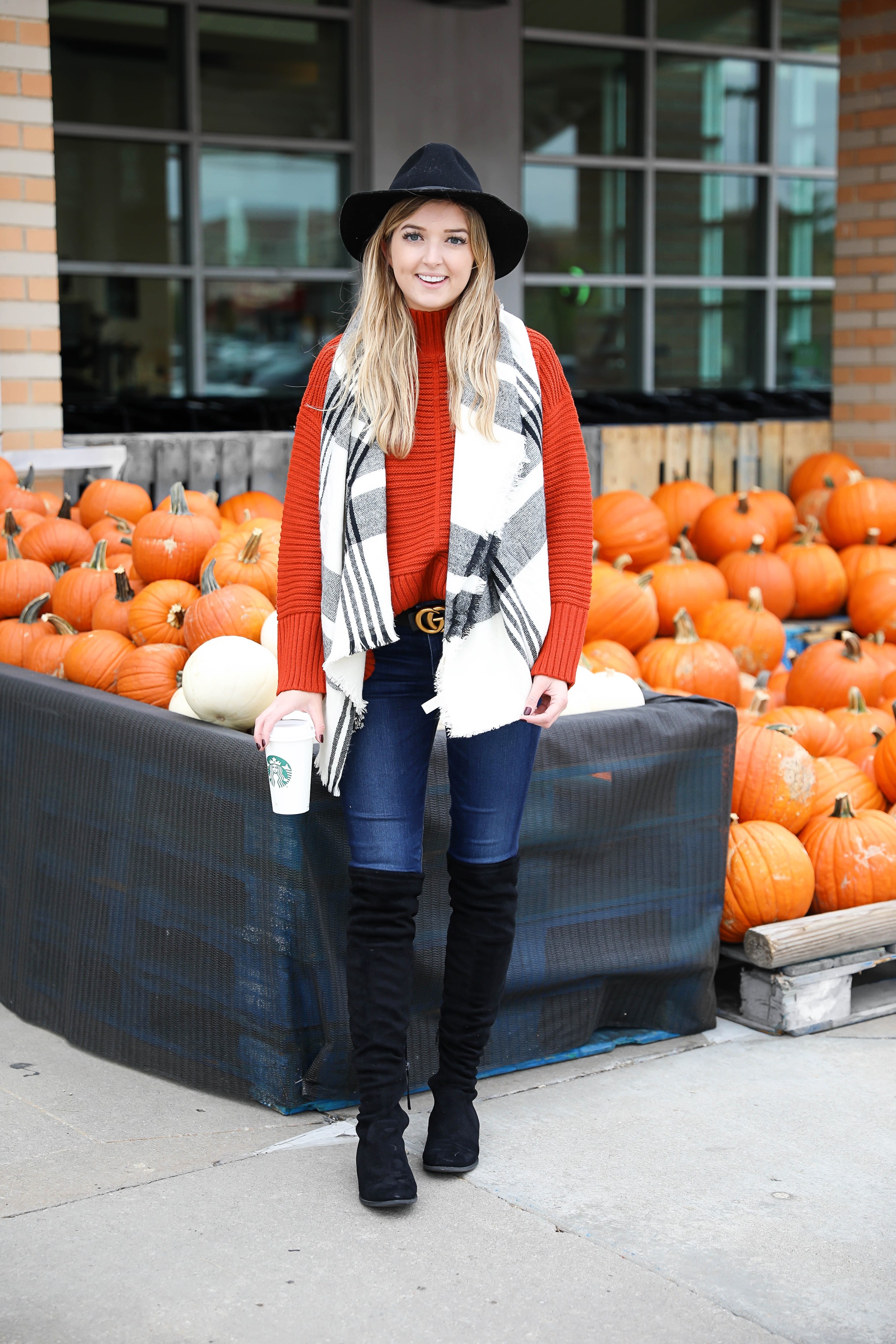 Orange Topshop sweater with a cute black and white scarf that doubles as a poncho! I paired this fall look with these $40 over the knee boots and my favorite black felt hat! Cutest fall outfit ideas on fashion blog daily dose of charm by lauren lindmark