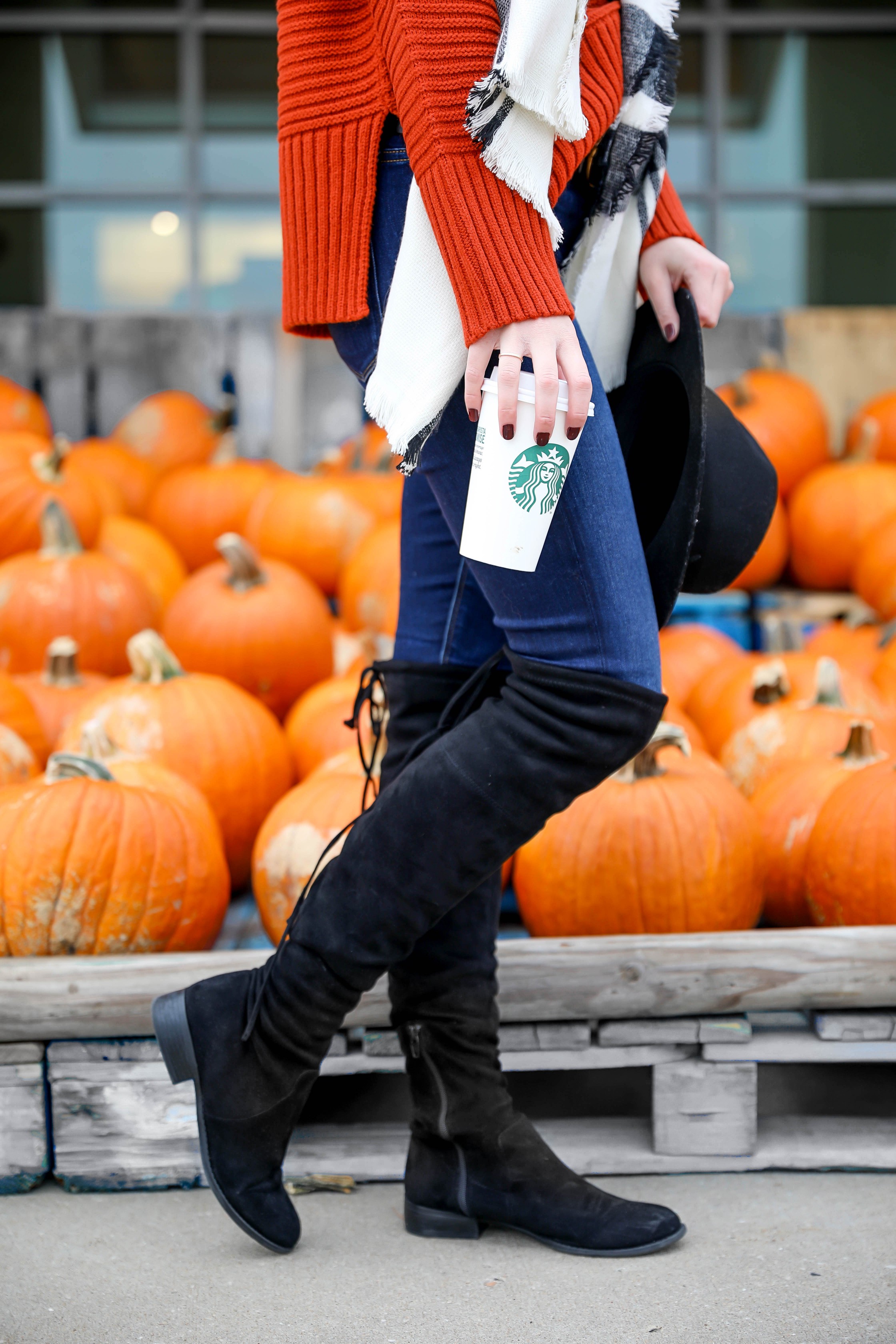 Orange Topshop sweater with a cute black and white scarf that doubles as a poncho! I paired this fall look with these $40 over the knee boots and my favorite black felt hat! Cutest fall outfit ideas on fashion blog daily dose of charm by lauren lindmark