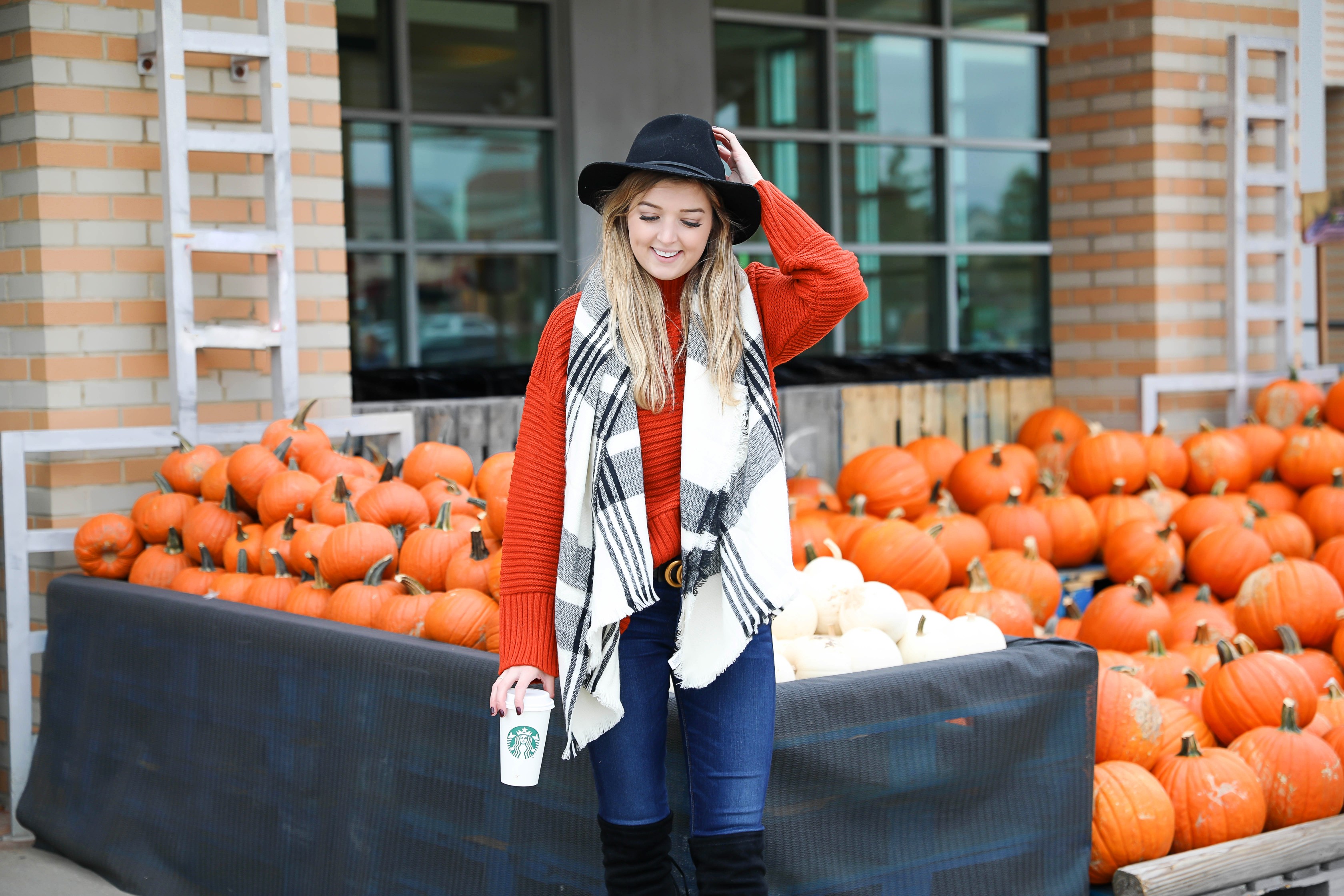 Orange Topshop sweater with a cute black and white scarf that doubles as a poncho! I paired this fall look with these $40 over the knee boots and my favorite black felt hat! Cutest fall outfit ideas on fashion blog daily dose of charm by lauren lindmark
