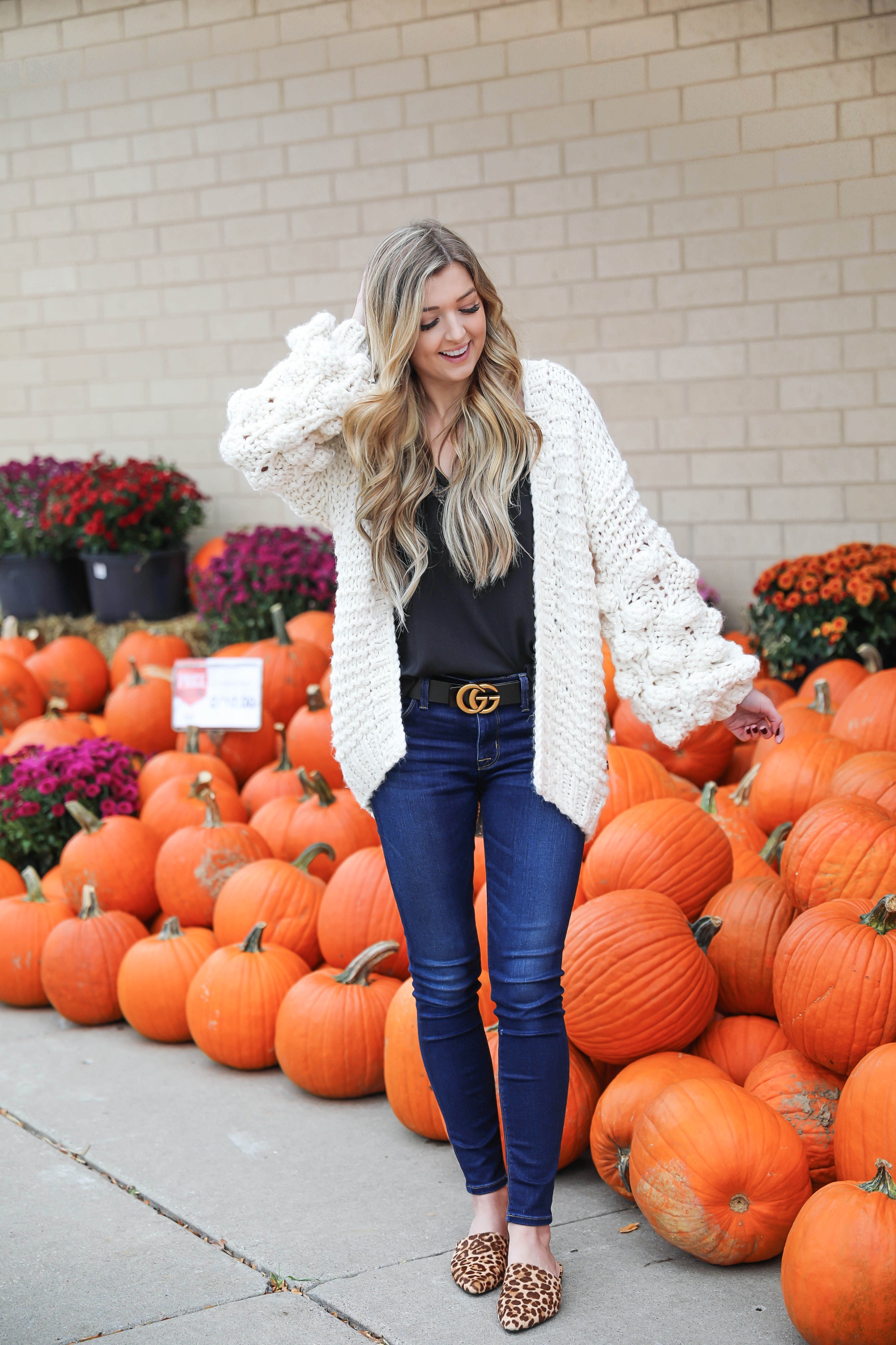 Puffy sleeve knit cardigan! I love finding unique ivory sweaters for fall and winter! I paired it with my favorite black lacey cami and gucci belt! Nothing like dark jeans and leopard shoes for fall! Details on fashion blog daily dose of charm by lauren lindmark