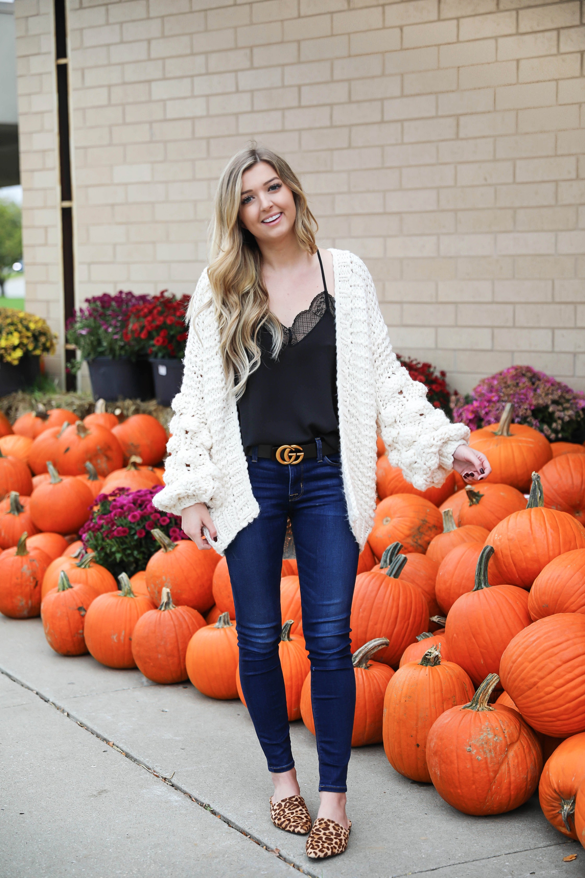 Puffy sleeve knit cardigan! I love finding unique ivory sweaters for fall and winter! I paired it with my favorite black lacey cami and gucci belt! Nothing like dark jeans and leopard shoes for fall! Details on fashion blog daily dose of charm by lauren lindmark