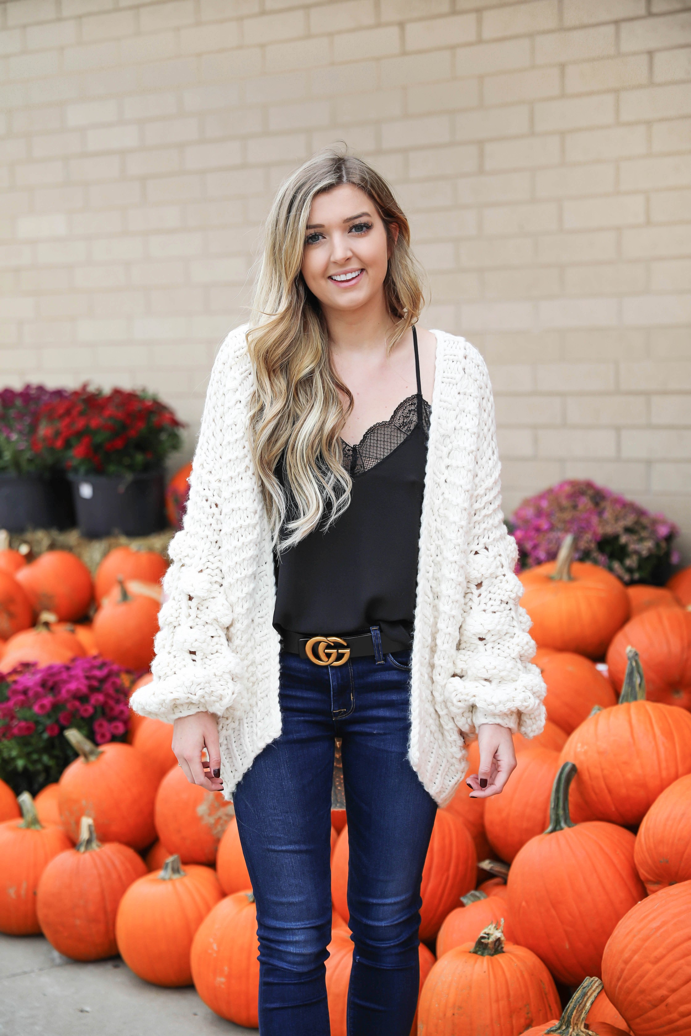 Puffy sleeve knit cardigan! I love finding unique ivory sweaters for fall and winter! I paired it with my favorite black lacey cami and gucci belt! Nothing like dark jeans and leopard shoes for fall! Details on fashion blog daily dose of charm by lauren lindmark