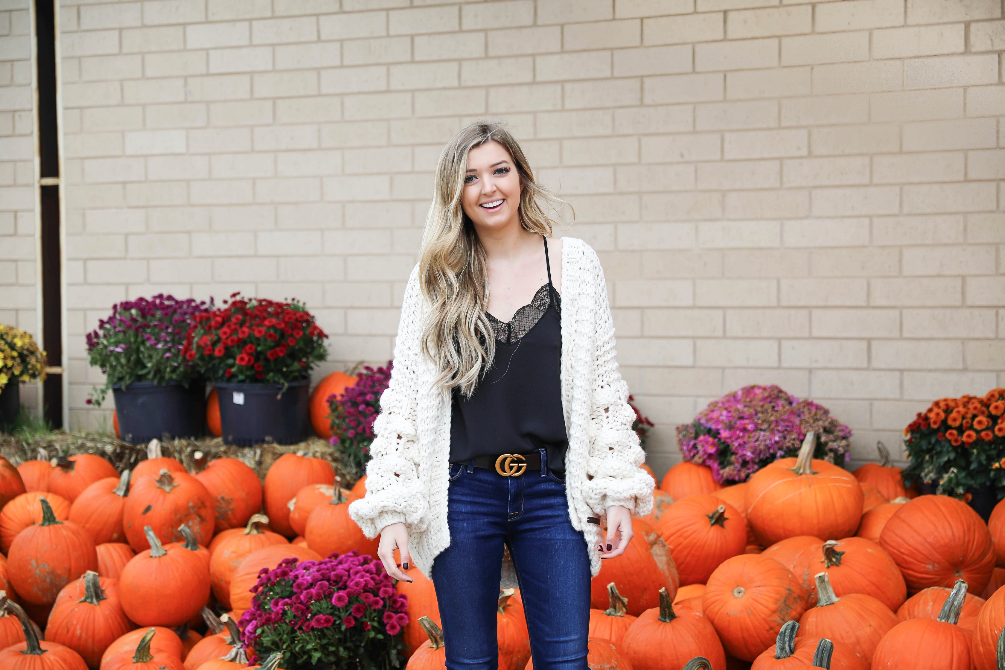 Puffy sleeve knit cardigan! I love finding unique ivory sweaters for fall and winter! I paired it with my favorite black lacey cami and gucci belt! Nothing like dark jeans and leopard shoes for fall! Details on fashion blog daily dose of charm by lauren lindmark