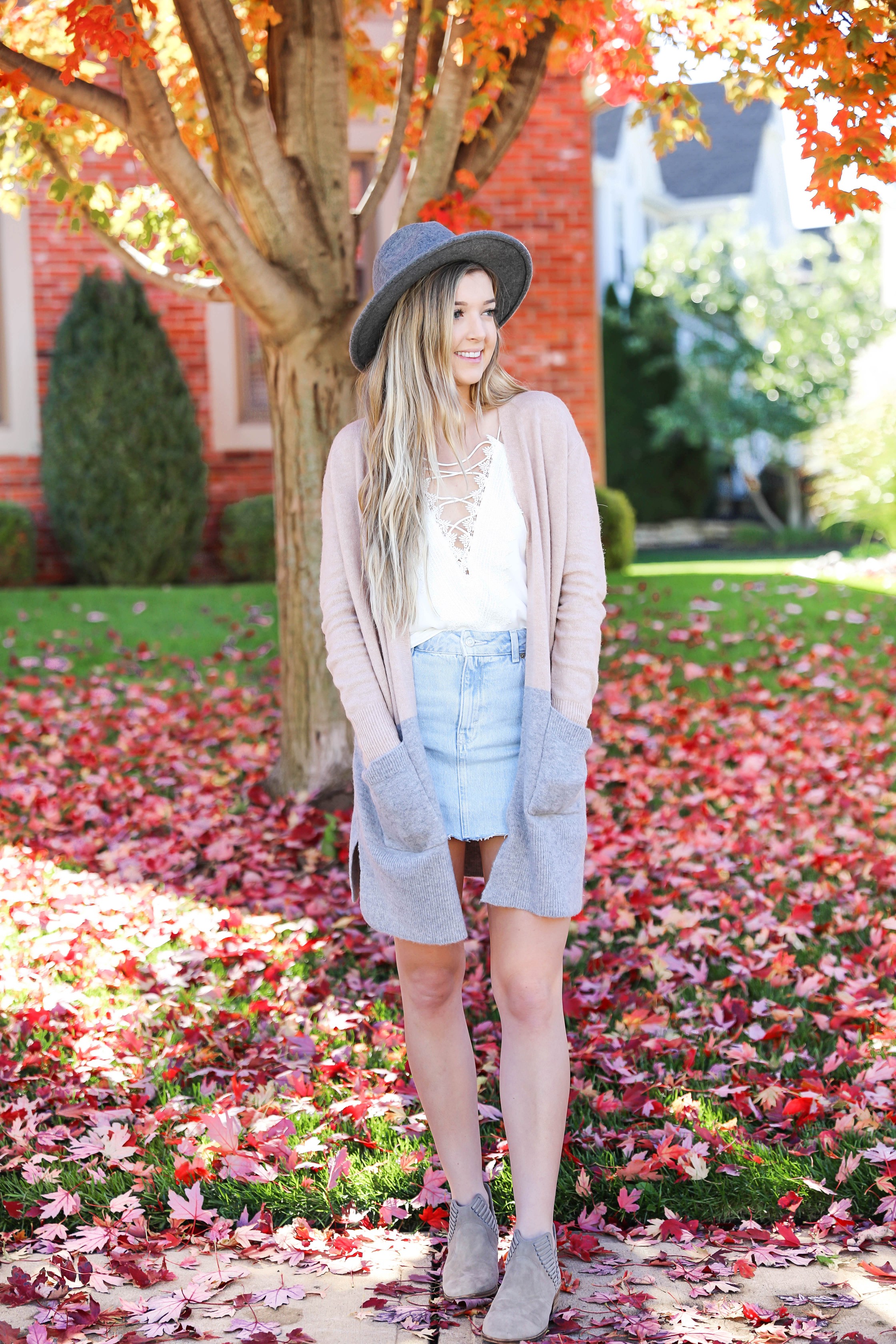 Two ways to style jean skirts in the fall! Jean skirt paired with a cute cardigan and jean skirt paired with a cropped sweater! Details on fashion blog daily dose of charm by lauren lindmark