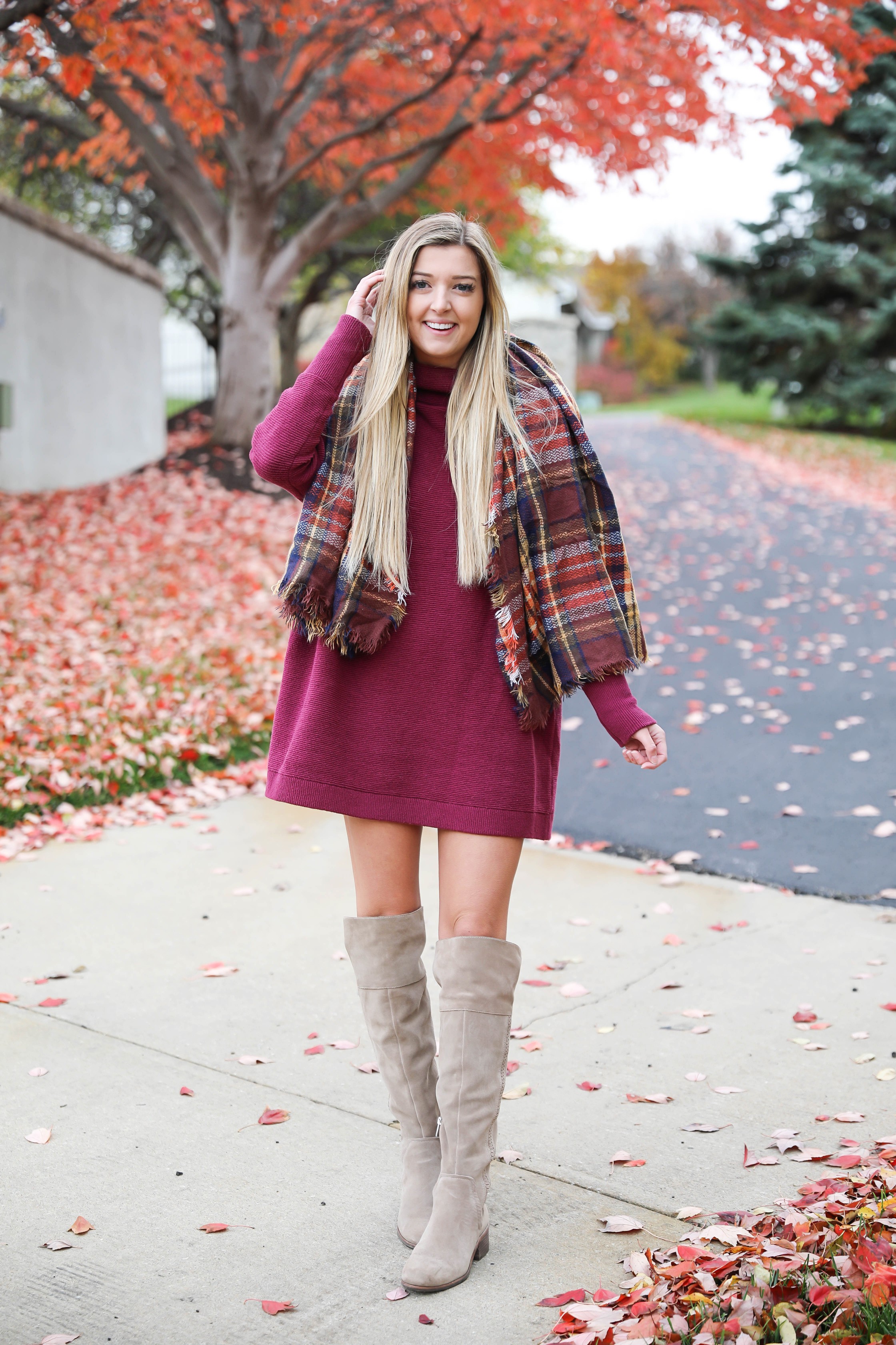 Burgundy sweater dress paired with a cute plaid scarf! Such a cute thanksgiving outfit! This cute fall dress is by free people and this plaid scarf look so cute with it! I paired it with my suede vince camuto over the knee boots! Details on fashion blog daily dose of charm by lauren lindmark