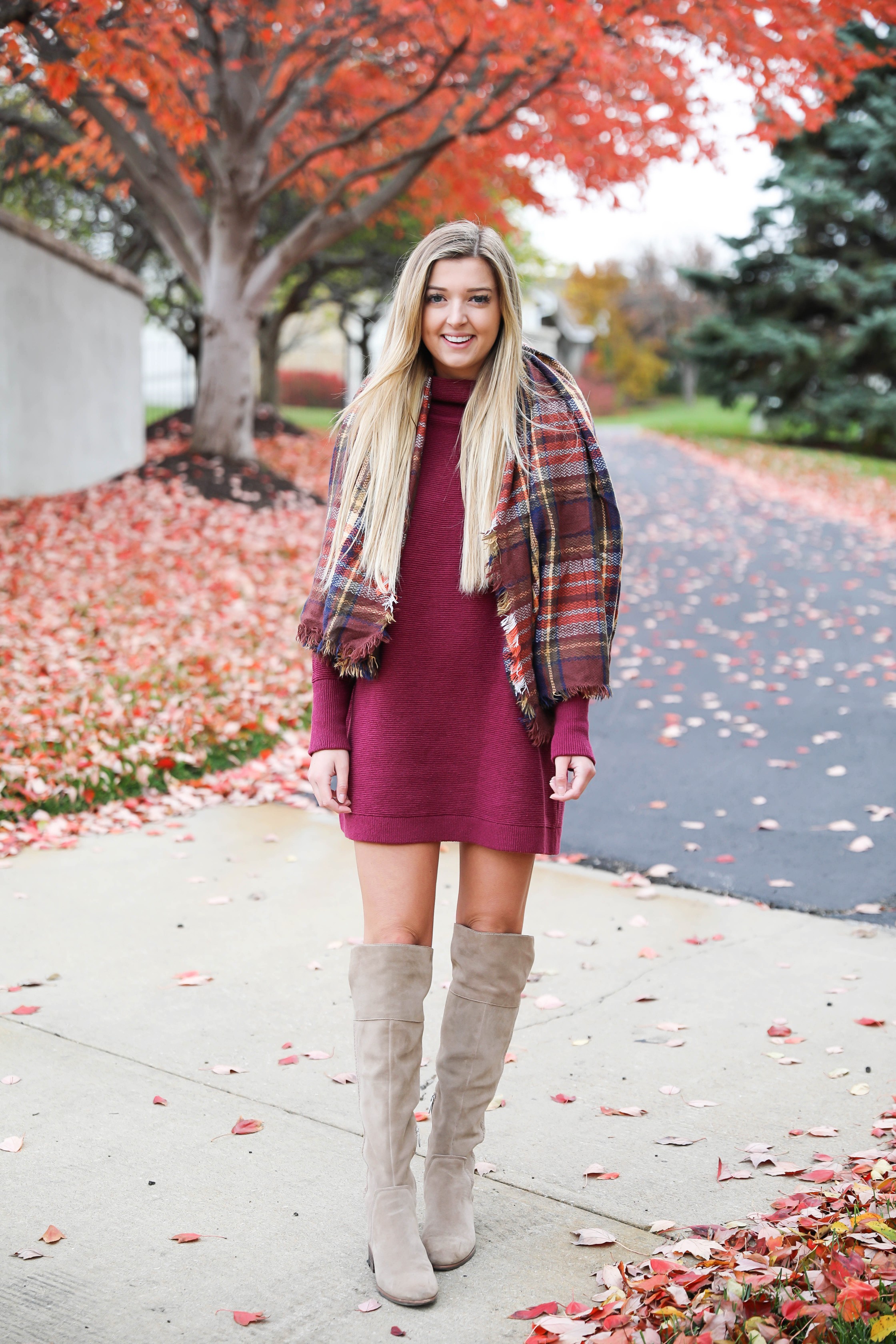 Burgundy sweater dress paired with a cute plaid scarf! Such a cute thanksgiving outfit! This cute fall dress is by free people and this plaid scarf look so cute with it! I paired it with my suede vince camuto over the knee boots! Details on fashion blog daily dose of charm by lauren lindmark