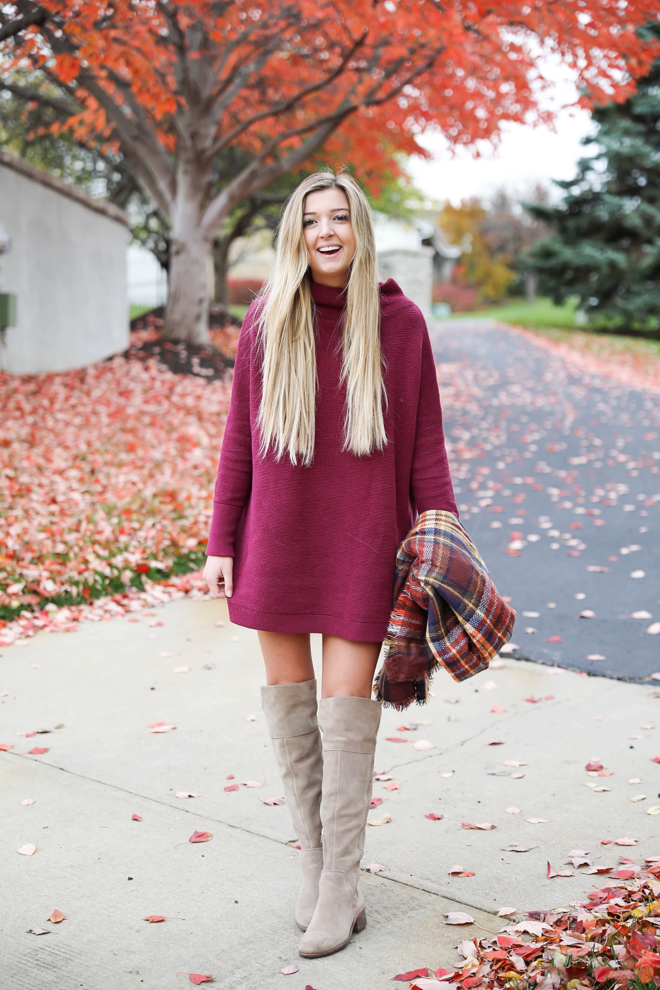 Burgundy sweater dress paired with a cute plaid scarf! Such a cute thanksgiving outfit! This cute fall dress is by free people and this plaid scarf look so cute with it! I paired it with my suede vince camuto over the knee boots! Details on fashion blog daily dose of charm by lauren lindmark