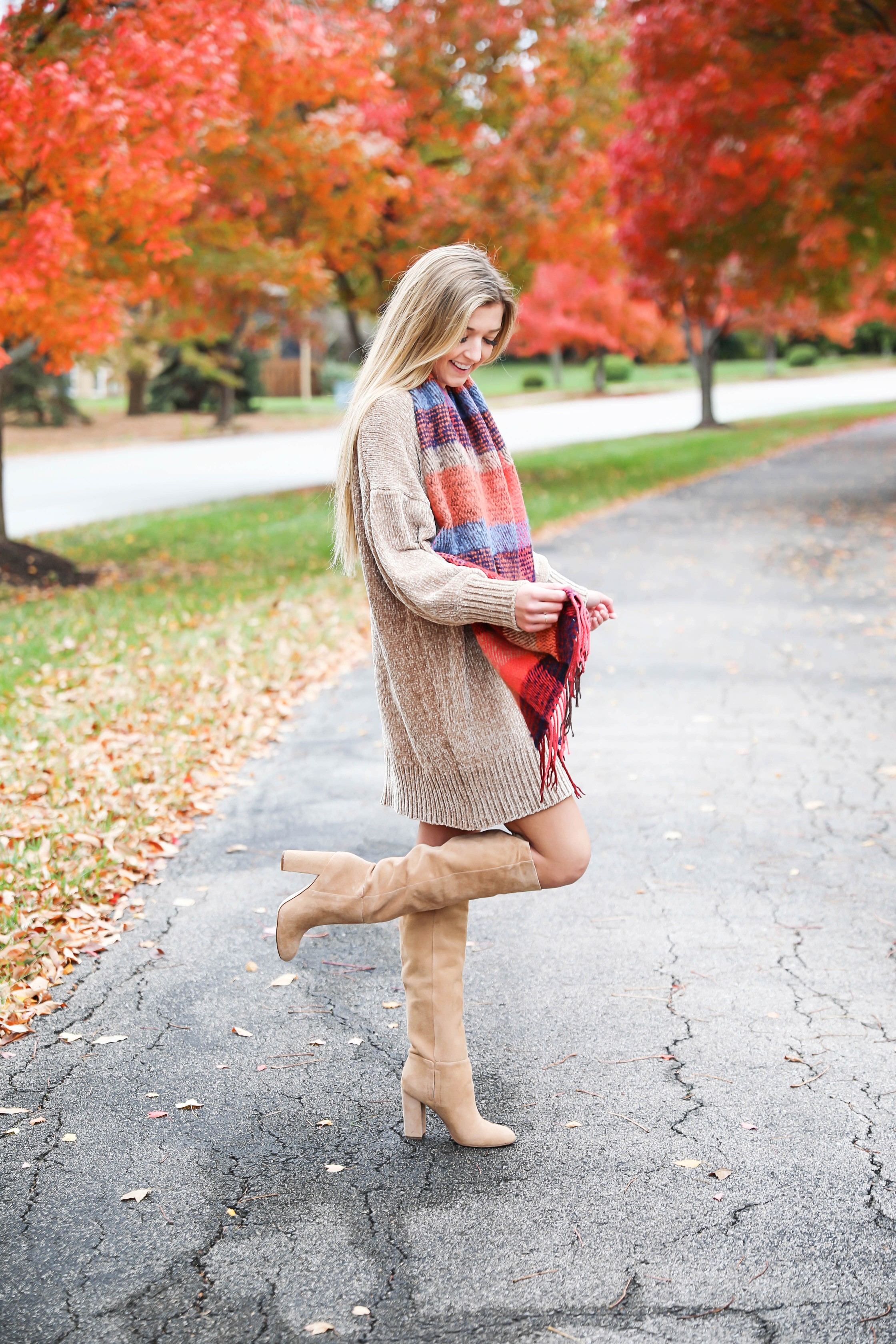 Chenille sweater dress form Red Dress Boutique! I love sweater dresses and chenille is my favorite trend for fall 2018! I paired it with this cute plaid scarf and my favorite tan boots! Nothing like a cute fall outfit in front of beautiful red autumn leaves on the trees! Details on fashion blog daily dose of charm by lauren lindmark