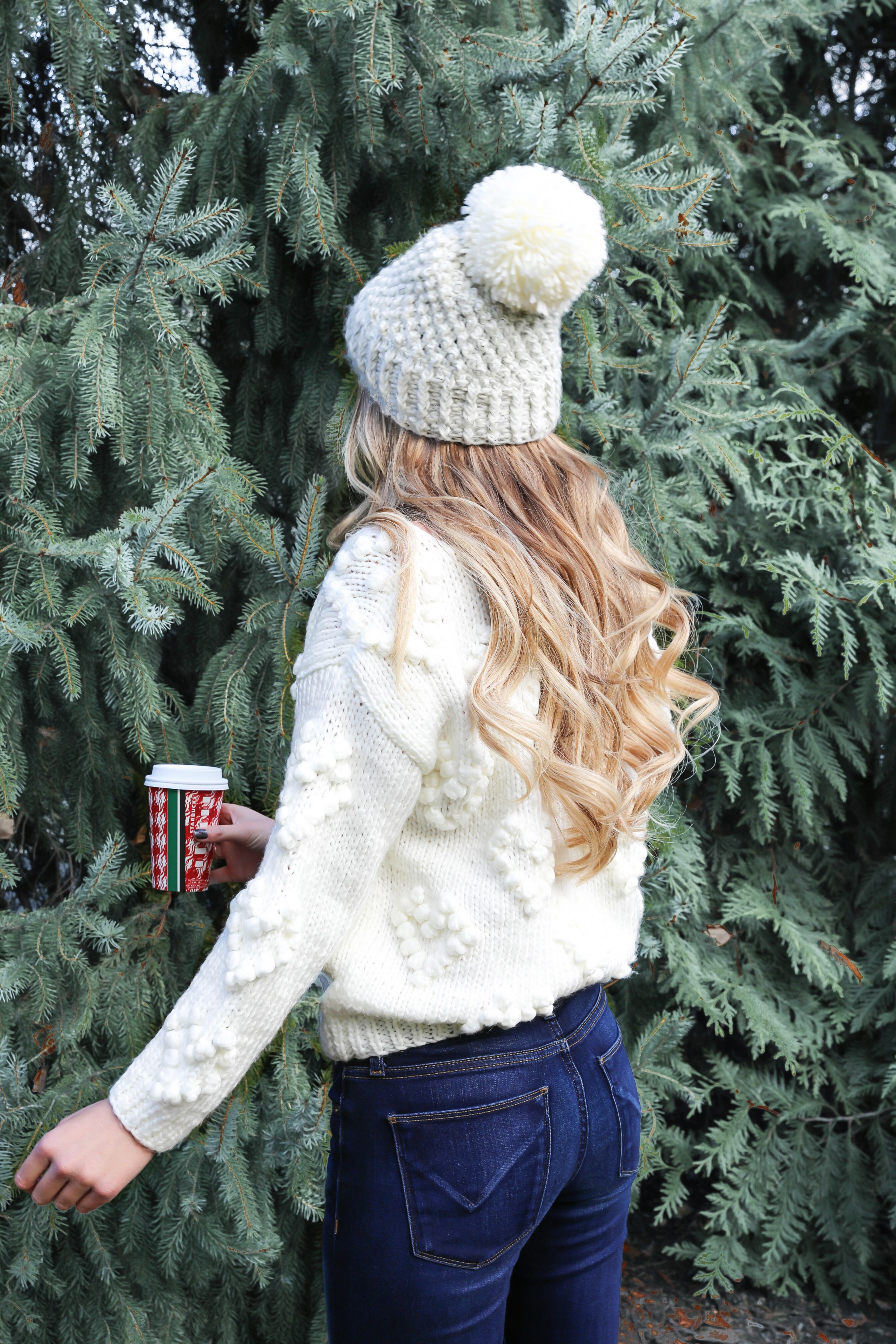 Christmas beanie roundup! The cutest winter hats that I am loving! Also wearing this cute chicwish heart pom sweater! Cute christmas tree photo idea! All details on fashion blog daily dose of charm by lauren lindmark