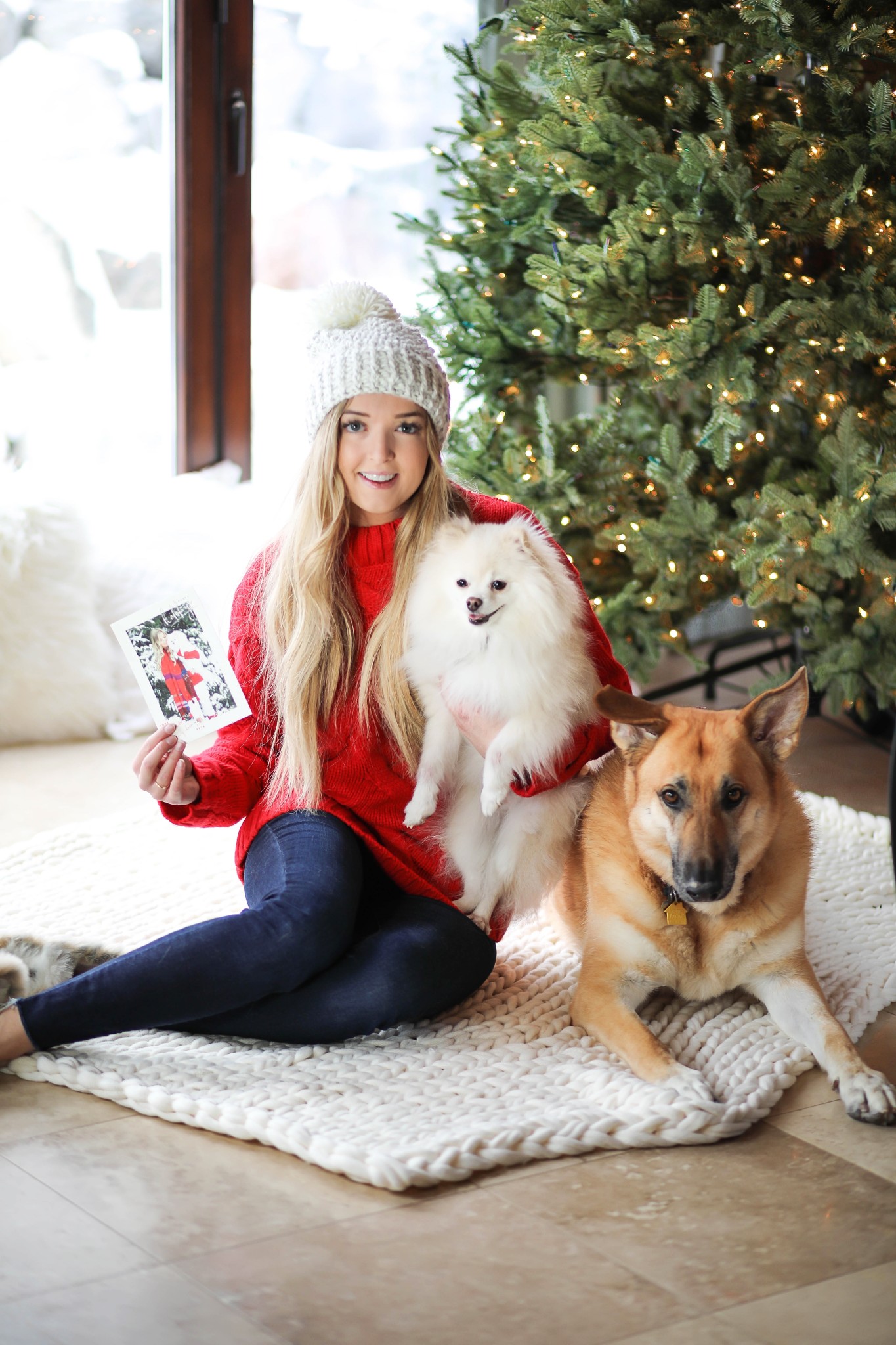 Christmas photos from Minted! The cutest holiday photos with my white pomeranian and German shephard! Dog holiday pictures are so cute! I am wearing this cute cable knit red sweater and beanie. All details on fashion blog daily dose of charm by lauren lindmark