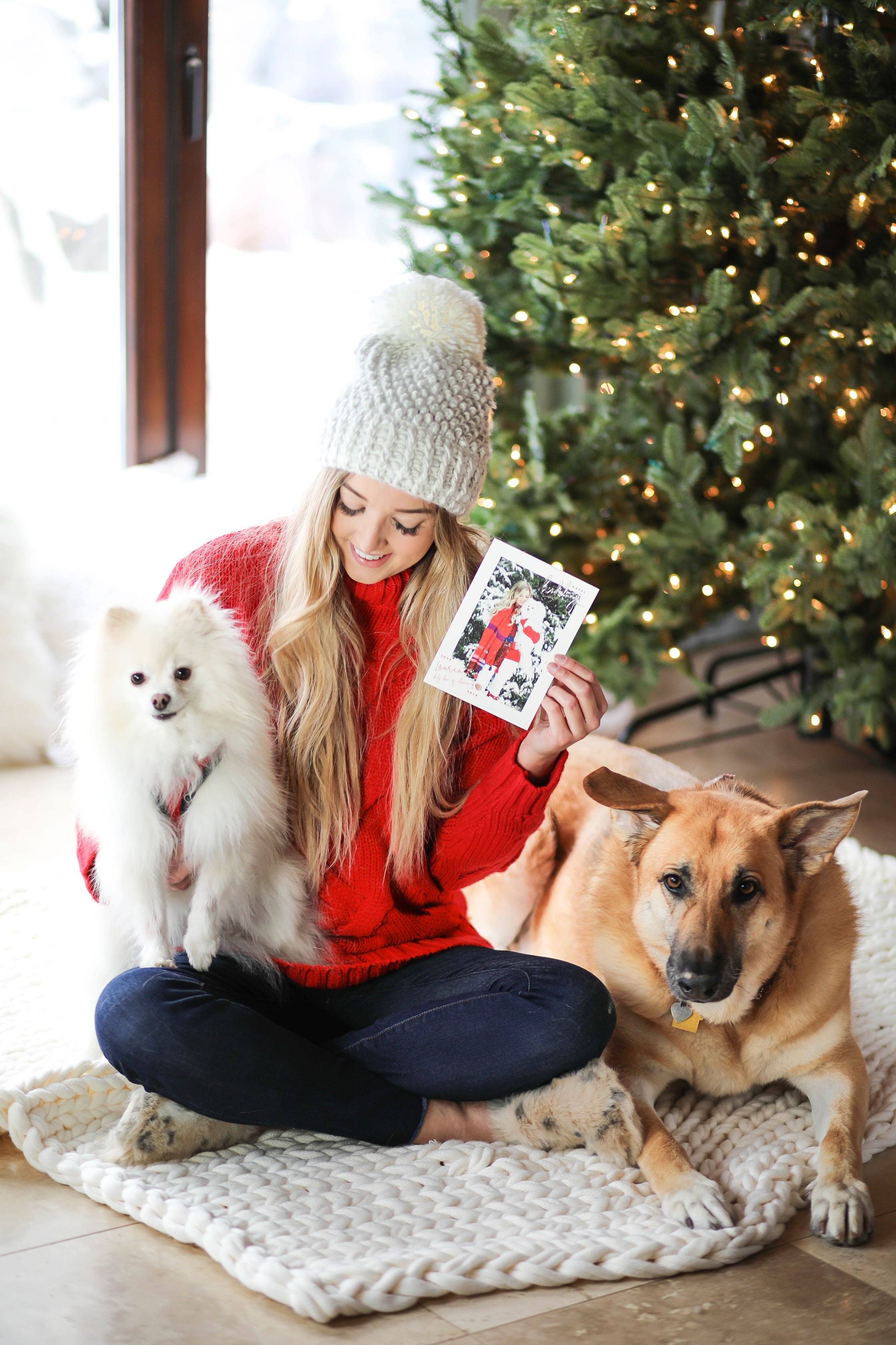 Christmas photos from Minted! The cutest holiday photos with my white pomeranian and German shephard! Dog holiday pictures are so cute! I am wearing this cute cable knit red sweater and beanie. All details on fashion blog daily dose of charm by lauren lindmark