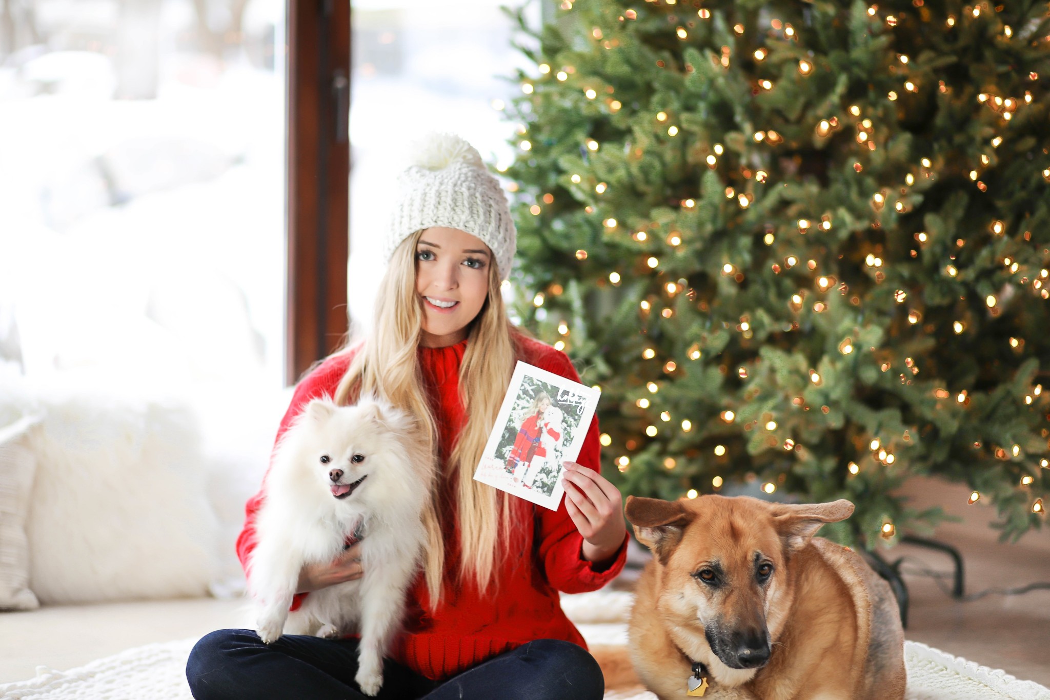 Christmas photos from Minted! The cutest holiday photos with my white pomeranian and German shephard! Dog holiday pictures are so cute! I am wearing this cute cable knit red sweater and beanie. All details on fashion blog daily dose of charm by lauren lindmark