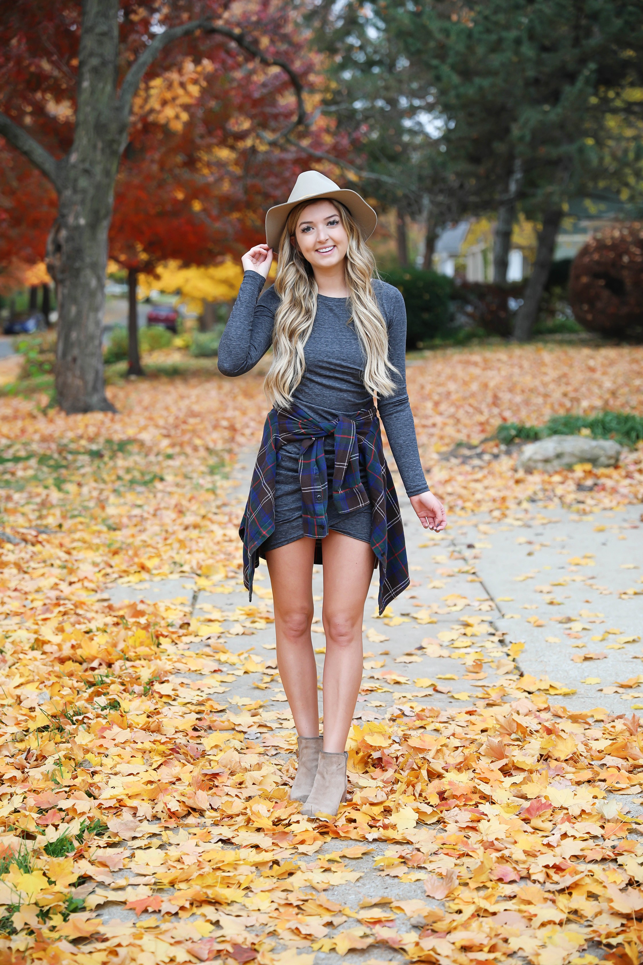 Gray long sleeve flattering dress with a cute flannel tied around the waist! These photos were taken in the prettiest fall leaves! I paired the outfit with this cute felt hat and suede booties! Details on fashion blog daily dose of charm by lauren lindmark