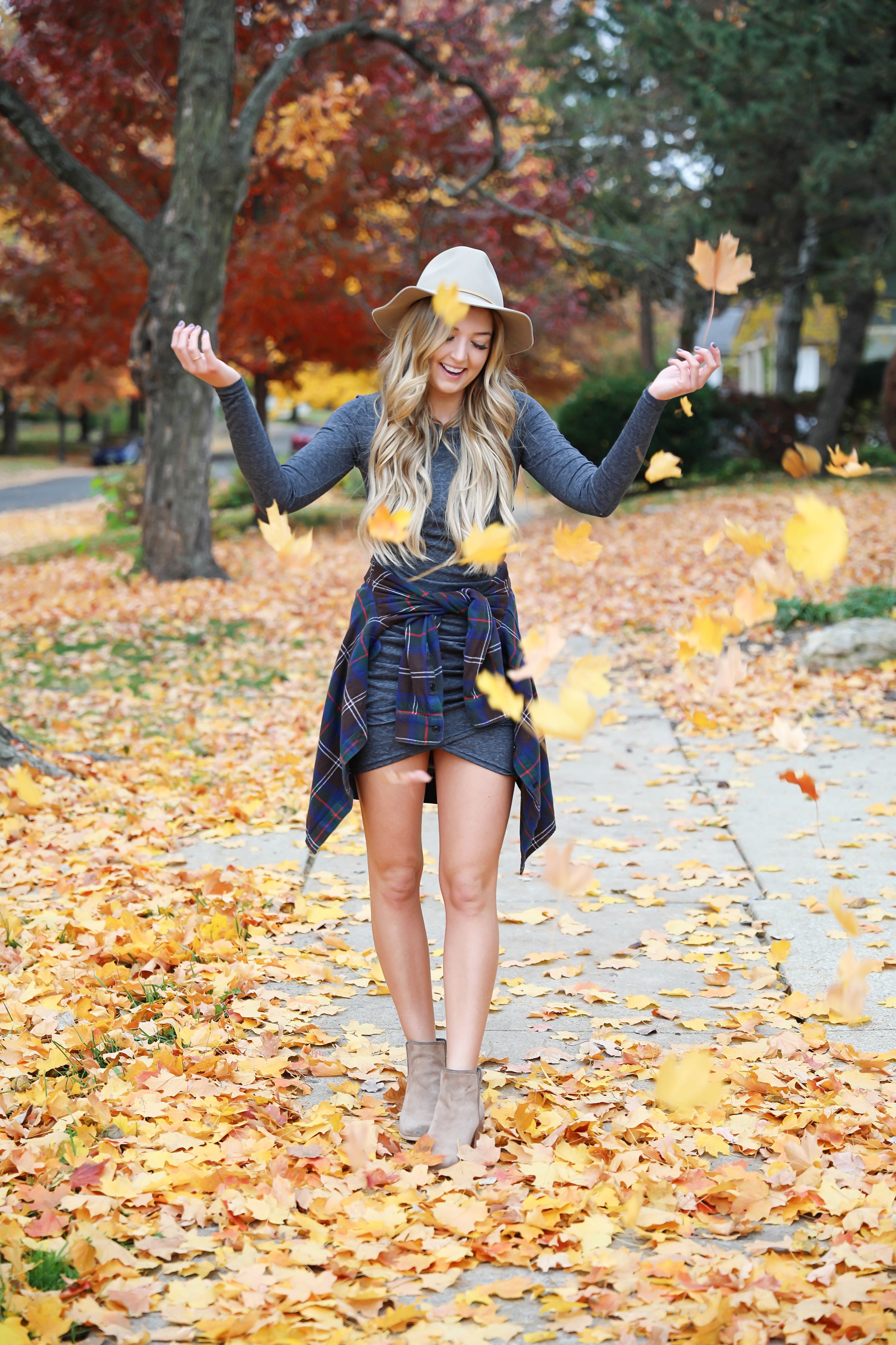 Gray long sleeve flattering dress with a cute flannel tied around the waist! These photos were taken in the prettiest fall leaves! I paired the outfit with this cute felt hat and suede booties! Details on fashion blog daily dose of charm by lauren lindmark